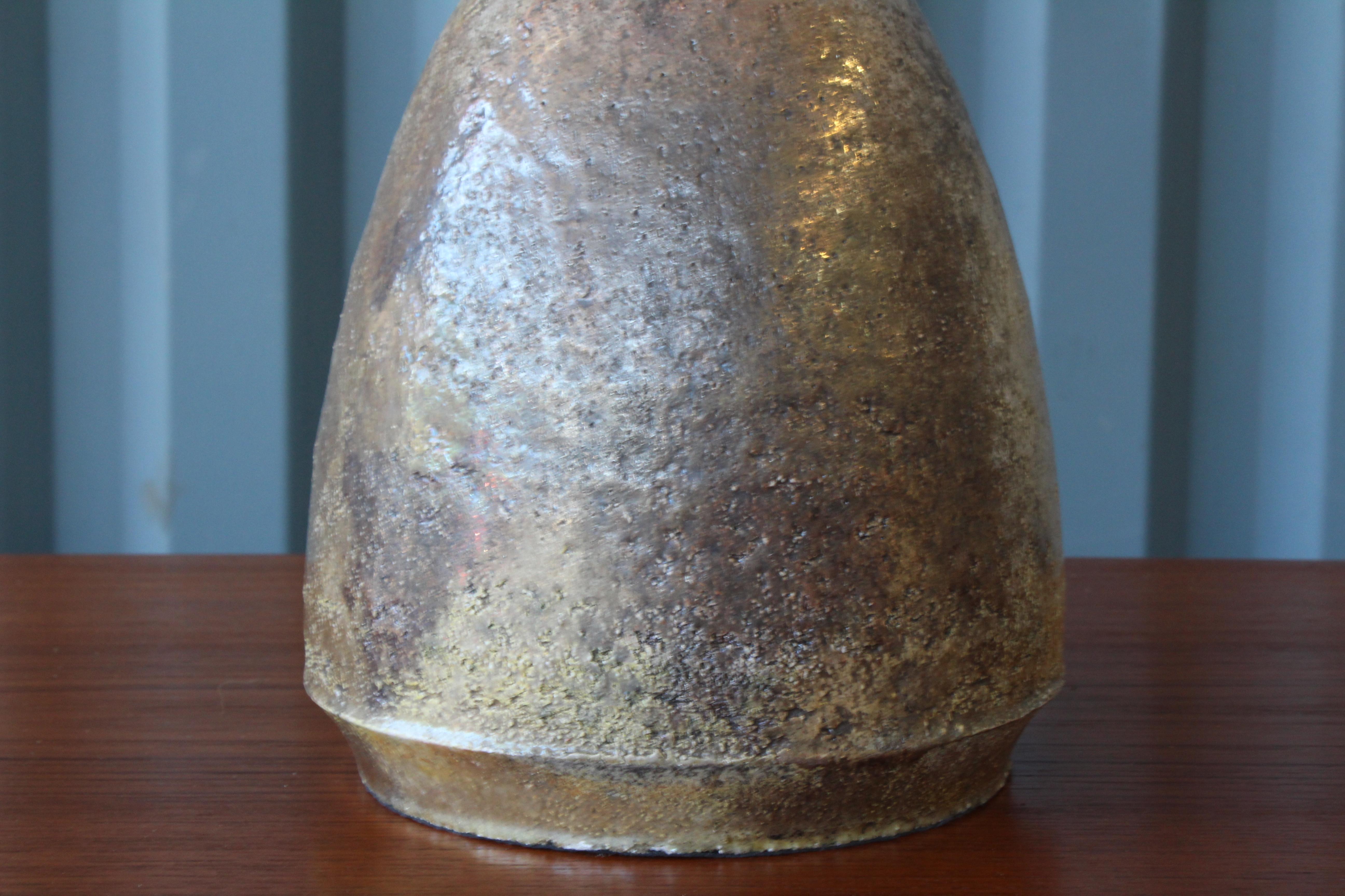 1960s French ceramic table lamp in a brown metallic glaze. Newly rewired and fitted with a custom linen shade.