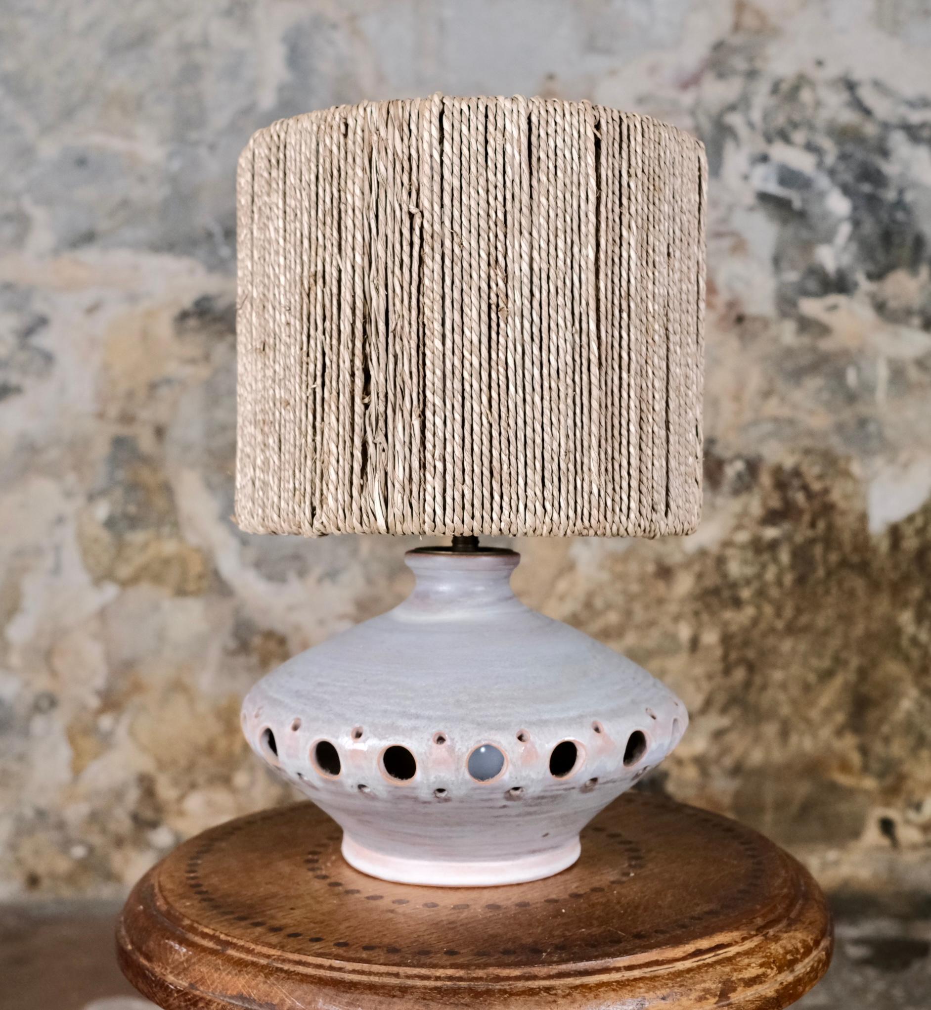 Pretty glazed ceramic lamp with openwork spherical decorations, made in France in the 1970s, in the style of Georges Pelletier.
Soft tones of gray, beige, and pink.
Two light sources (one inside the body).
Sold with or without the lampshade.