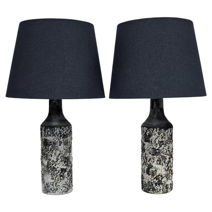 A special table lamp pair designed as a birch tunk by Bruno Karlsson for Ego Stengods Atelje, Sweden 1970s. The lamps have speckled grey, brown and and white mix of colors as in the birch tree and with a rough and knotted realistic forest texture.