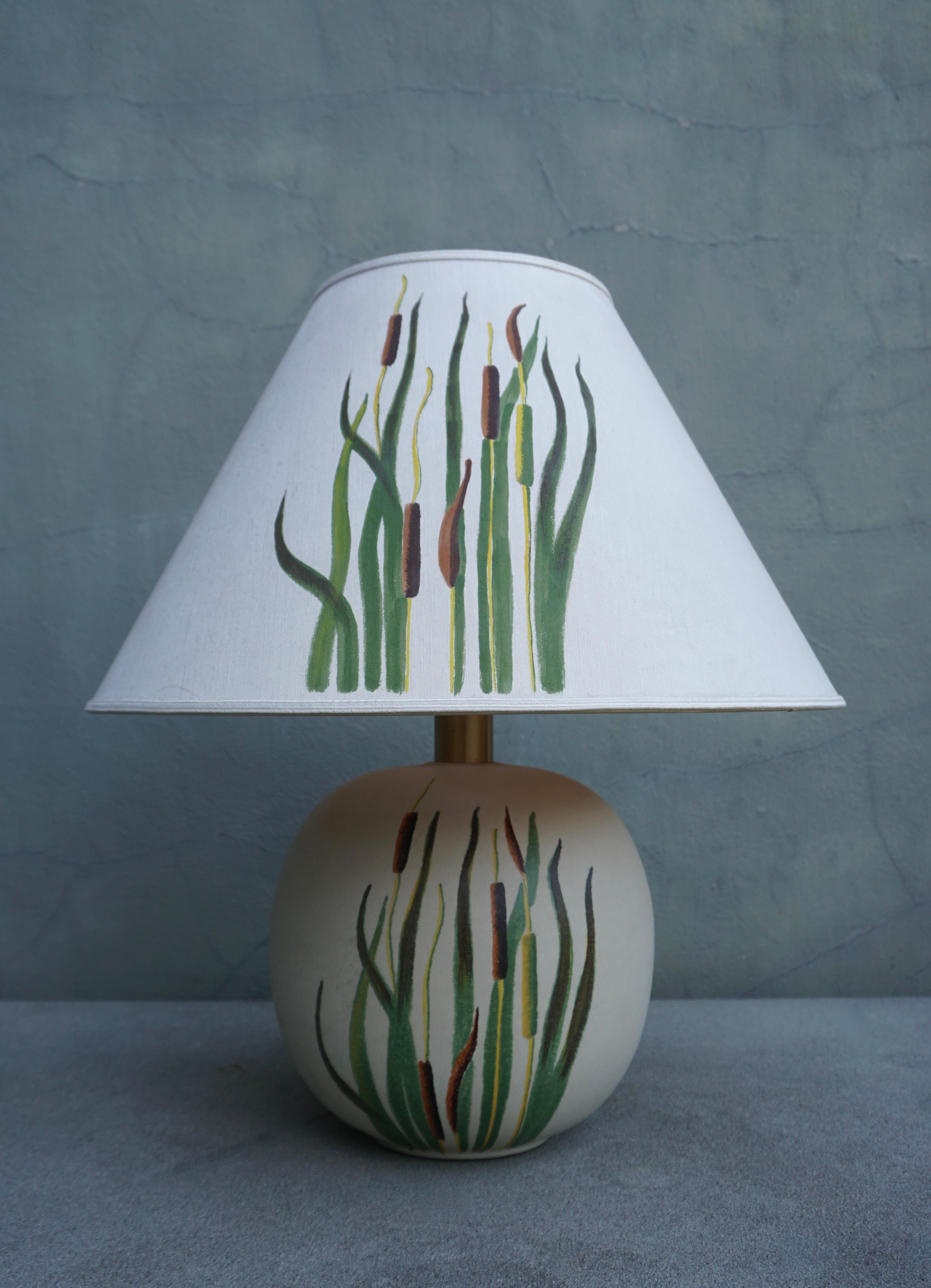 Beautiful ceramic table lamp with botanical representation of cattails grass.

Height 24.8