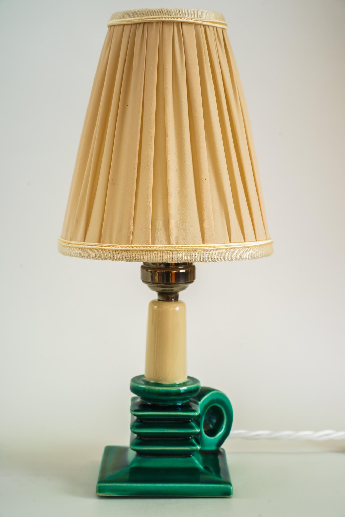 Ceramic table lamp with fabric shade around 1920s
The fabric is replaced ( new ).