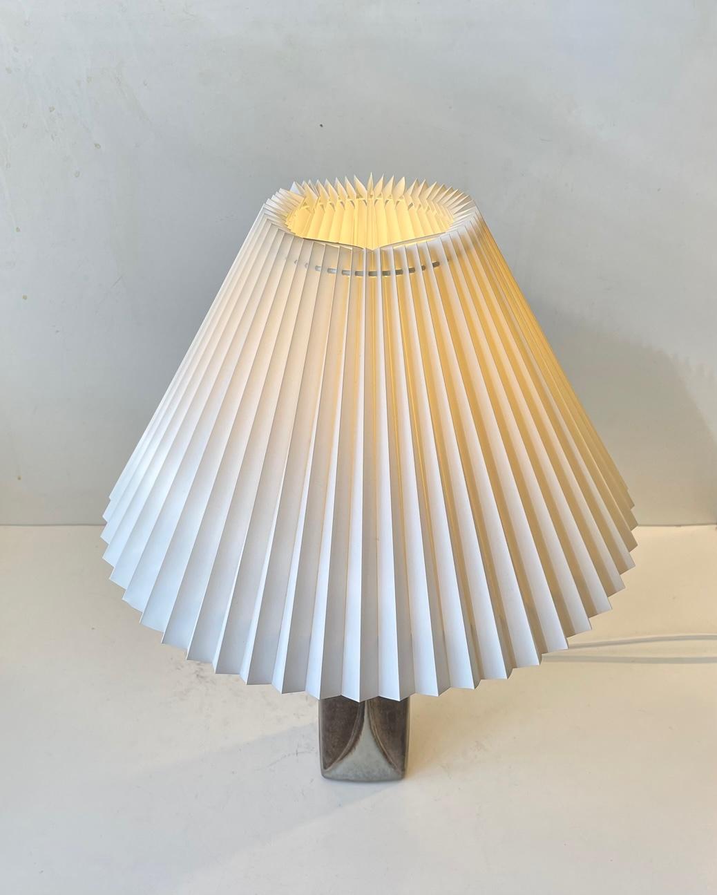 Table lamp designed by Marianne Starck for Michael Andersen & Son, Denmark. Decorated with glazed leaves in earthy tones. It features its original bakelite socket with pin on/of switch. The height of 18 inches (45 cm) is with shade. Its installed