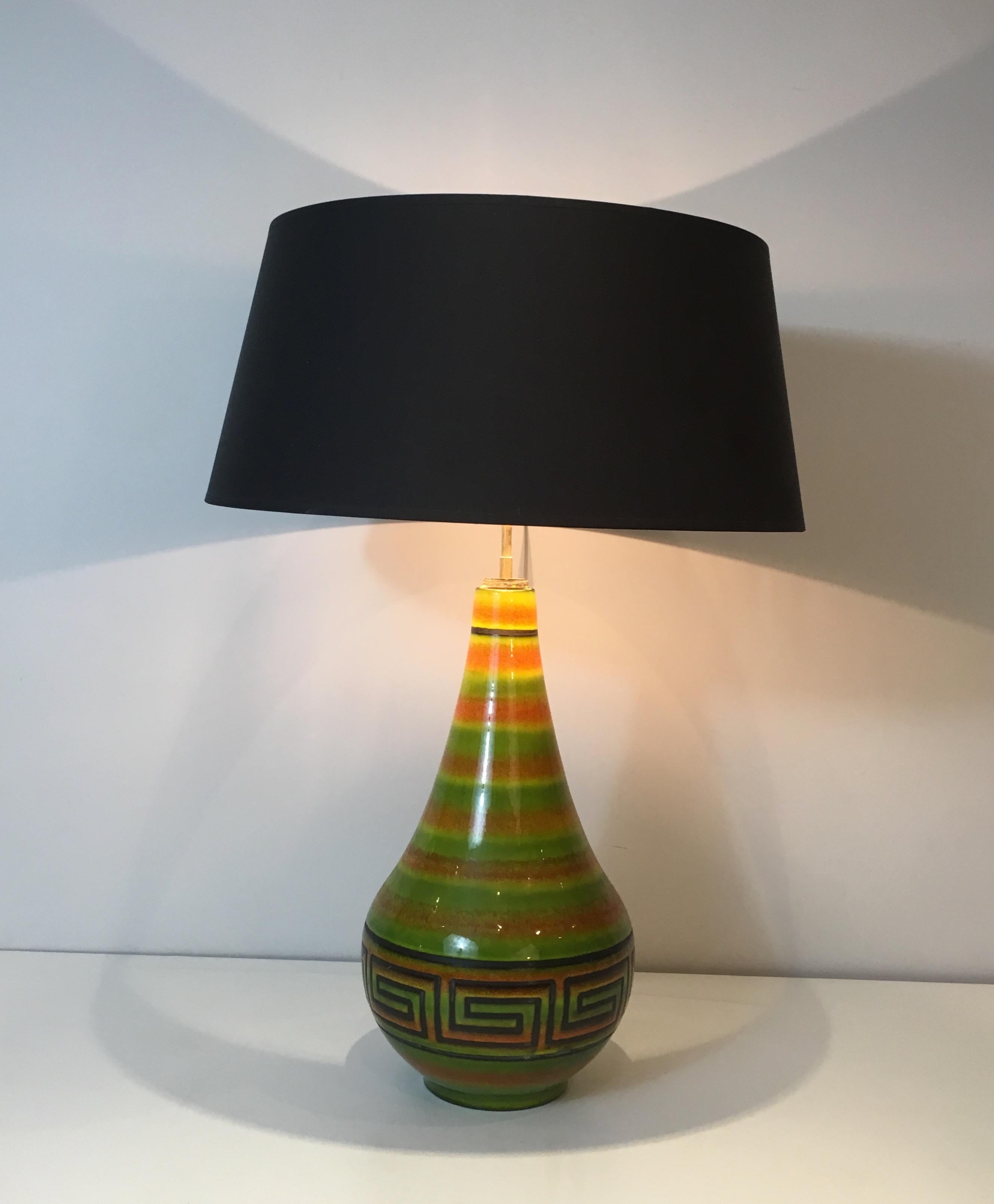 This table lamp is made of ceramic with Greek key decors. This is a French work, circa 1970.