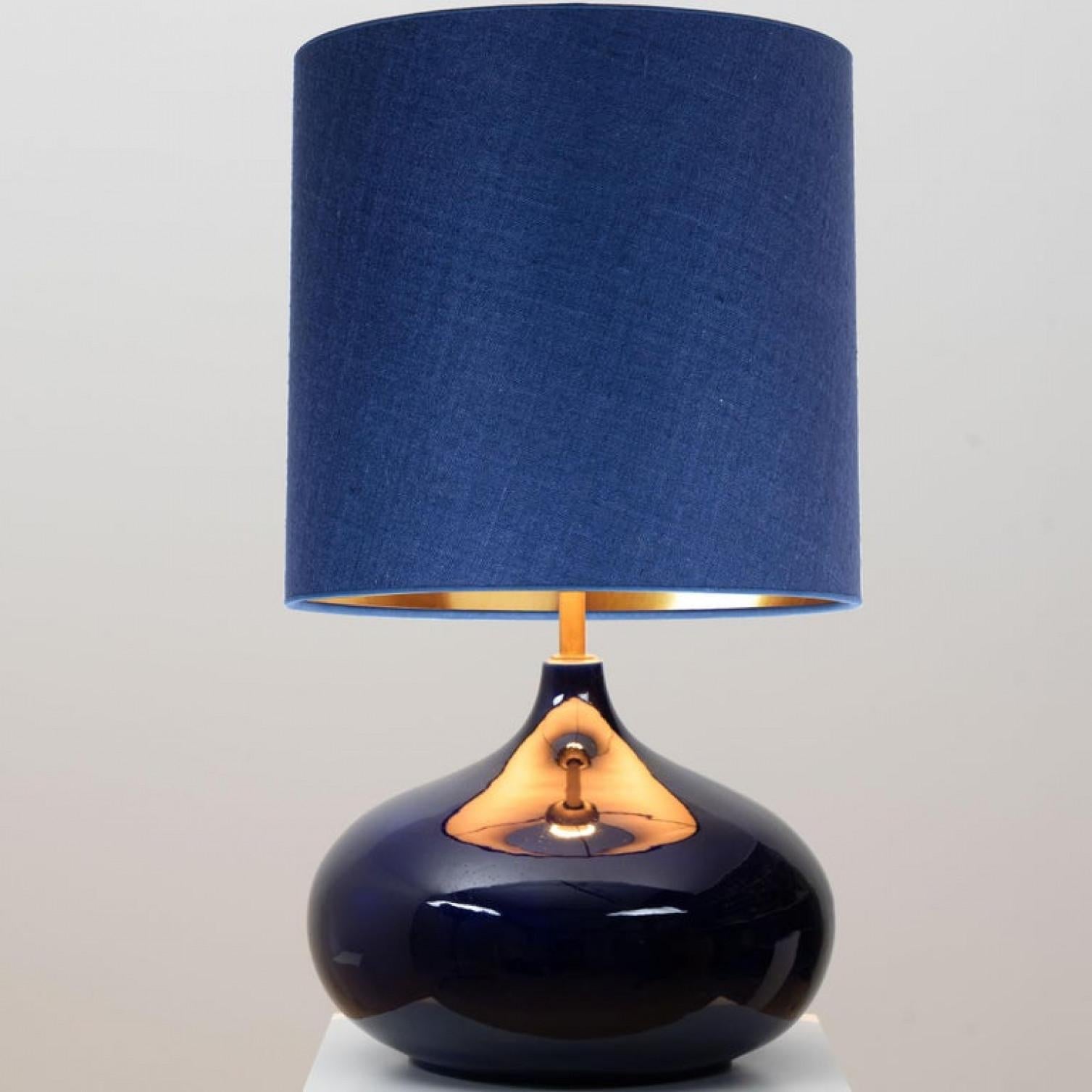 Tischlampe aus Keramik, Dänemark, 1960er Jahre. Ein skulpturales, hochwertiges Stück aus handgefertigter Keramik in reichhaltig glasierten, dunkelblauen Tönen. Mit einem neuen, maßgefertigten Lampenschirm aus blauer Seide mit warmem Gold im Inneren,