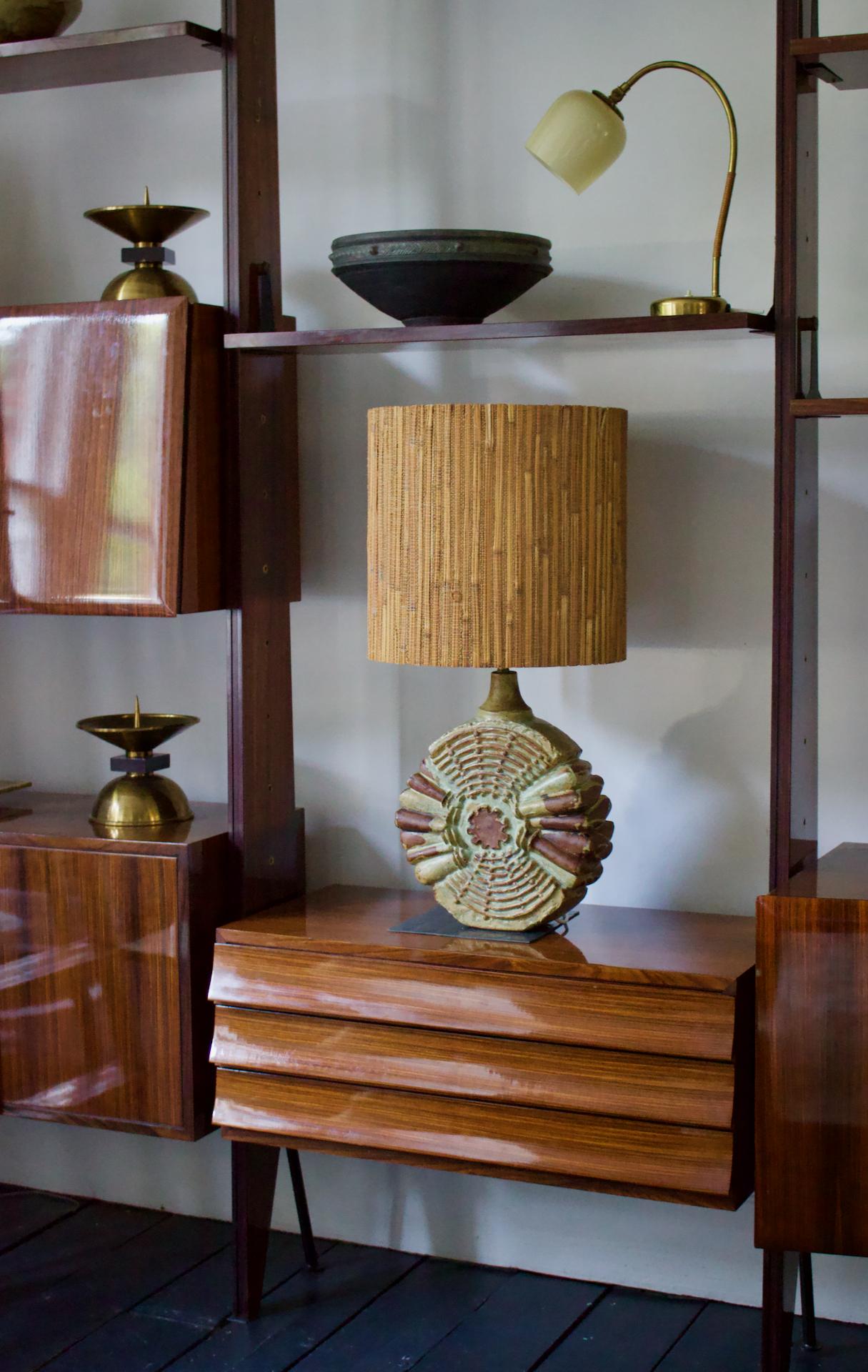 Mid-century table lamp by British ceramic artist Bernard Rooke, with its original rattan-covered shade. See notes on condition, shade and wiring/bulb below.

The ceramic base is broadly circular in shape, with abstract decoration in a mixture of