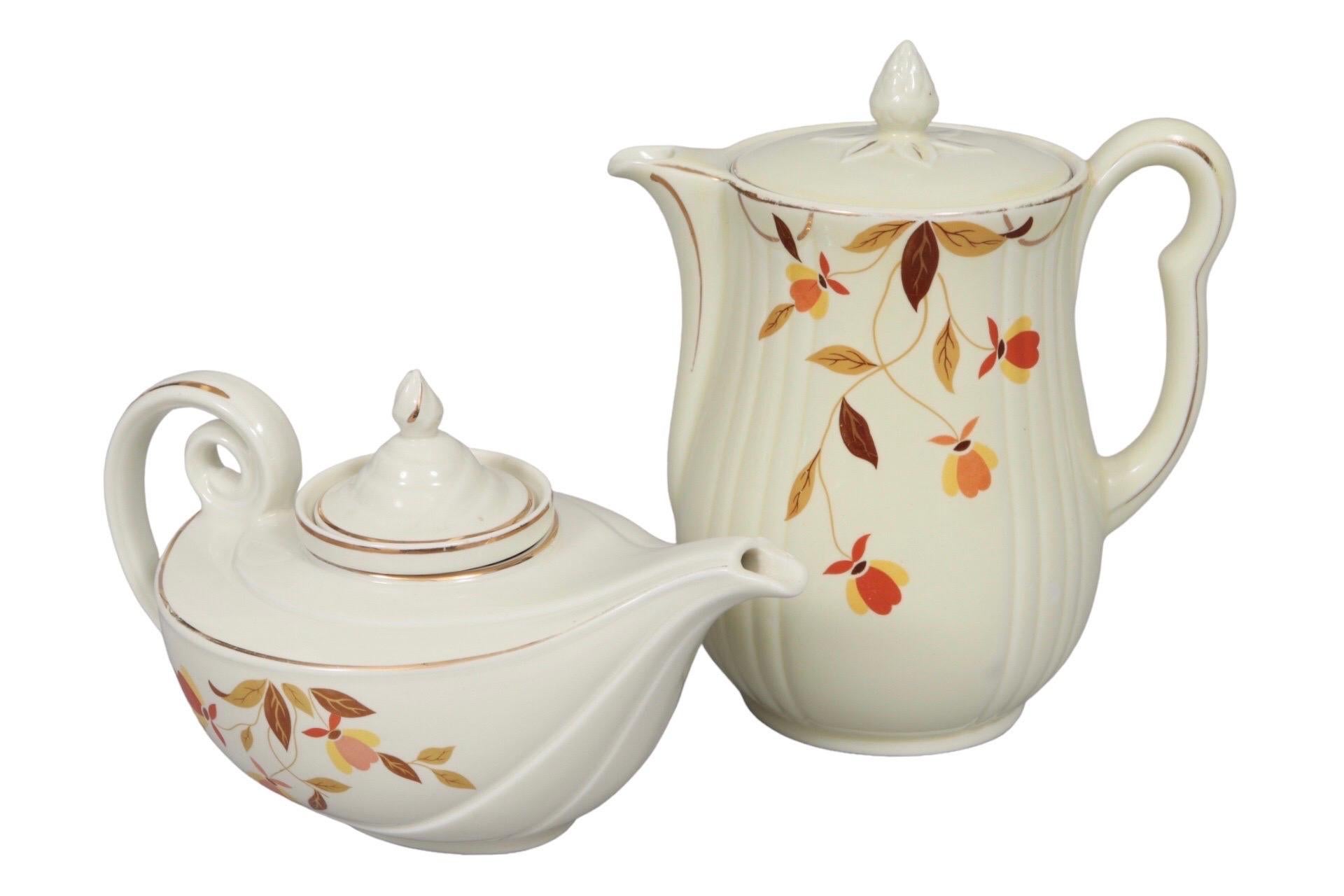 A ceramic tea and coffee pot set in the Autumn Leaf pattern by Hall's. This pattern was produced exclusively for Jewel Tea Company and was discontinued in 1976. Teapot measures 11