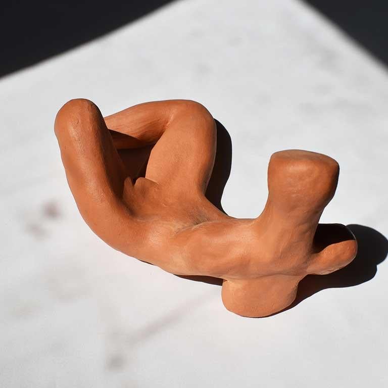 Contemporary figural unglazed terracotta sculpture of an abstract reclining figure. An homage to sculptor Henry Moore. Made in 2019 by Oklahoma artist Emily Ladow Reynolds. 

Dimensions: 8