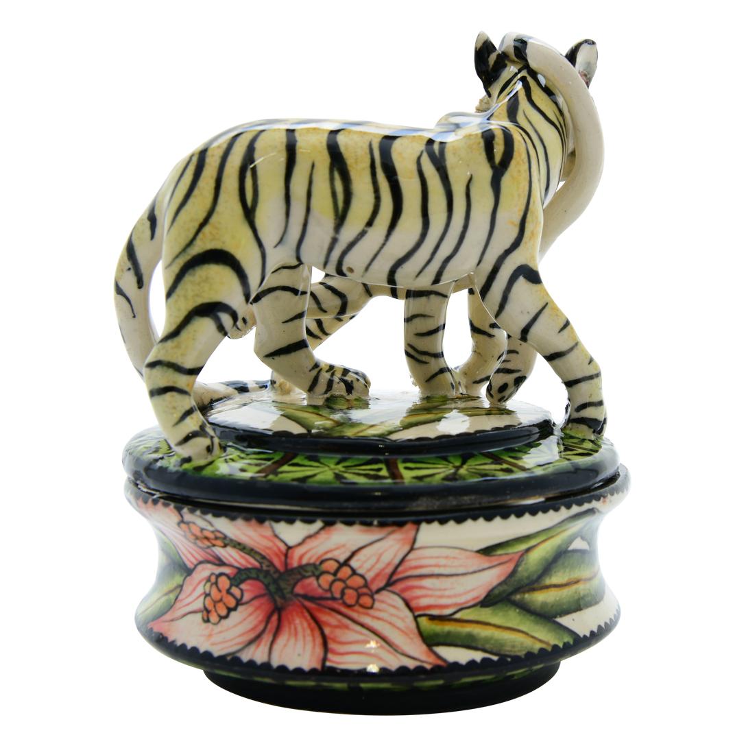 
Crafted by artisans Lefu and Samkelo at Senzo Duma Ceramics in South Africa, this ceramic Tiger jewelry box stands 6 inches high, 4 inches long, and 4 inches wide. Hand-sculpted with intricate detail, it embodies the essence of African wildlife.