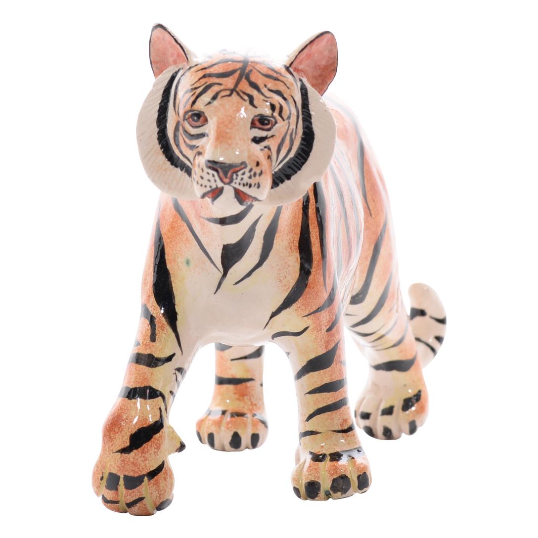 Imvelo Natural Art presents a striking ceramic Tiger sculpture from South Africa. Sculpted by Bernard and hand-painted by Sbusiso, this piece measures 6 inches high, 11 inches long, and 3 inches wide. The sculpture captures the majestic aura and raw
