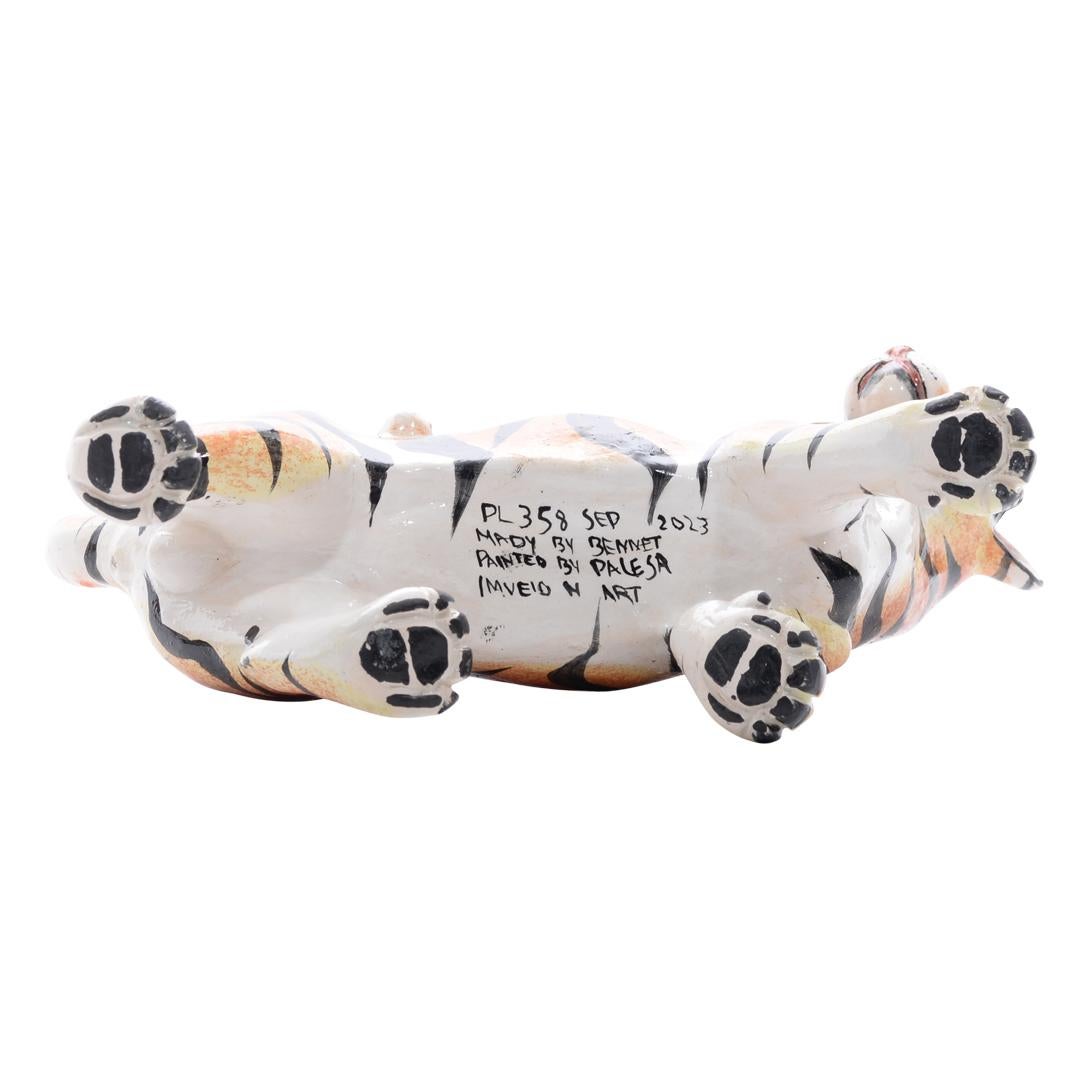 
Handcrafted in South Africa by local artisans under the brand Imvelo Natural Art, this tiger sculpture ceramic exudes raw beauty and artistic finesse. Sculpted by Bennet and painted by Palesa, it stands 7 inches tall with a length of 10 inches and