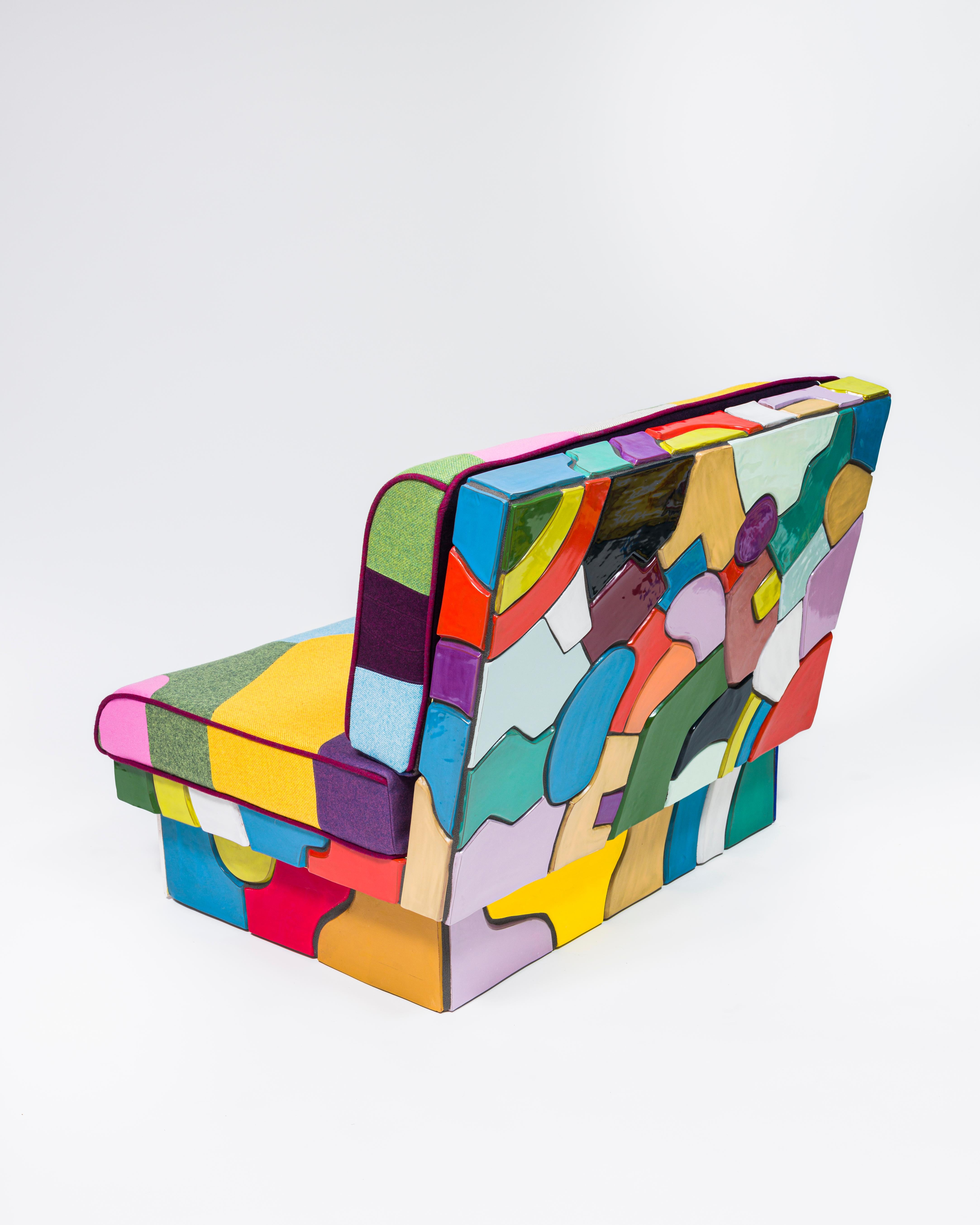 Double-wide lounge chair with ceramic tiled base (supported with a wooden structure) made with a custom patchwork upholstery in wool and wool blends from Maharam's line of upholstery fabrics. All of the tiles are hand made as are the glaze colors,
