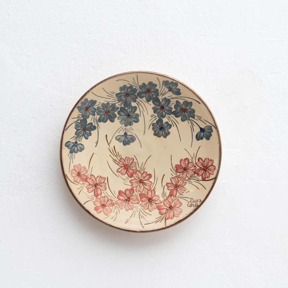 Ceramic hand painted plate artwork by Catalan artist Diaz COSTA, circa 1960.    In original condition, with minor wear consistent of age and use, preserving a beautiful patina.    Signed.