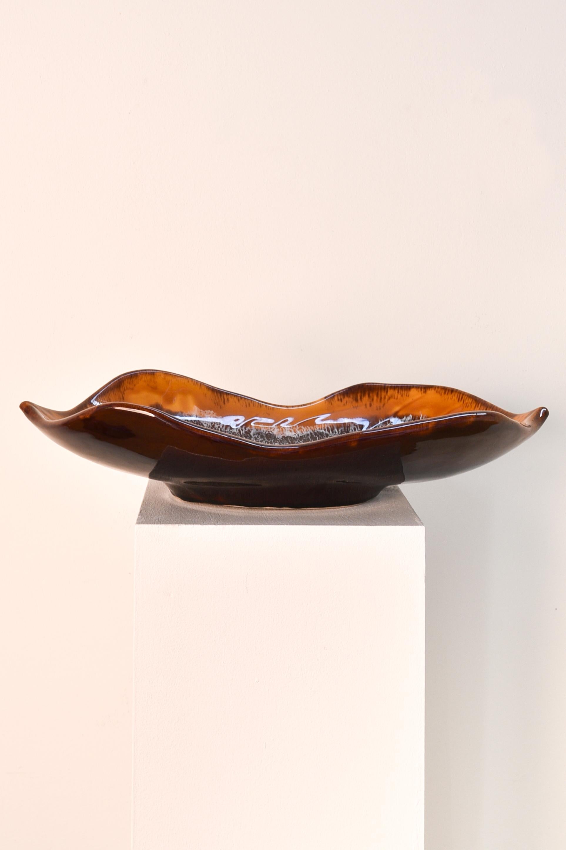 Ceramic tray in the shape of a brown leaf, signed Vallauris.
Vallauris is a town on the French Riviera between Antibes and Cannes and also called 'city of 100 potteries'. It used to be the centre of ceramic pots and became even more popular when