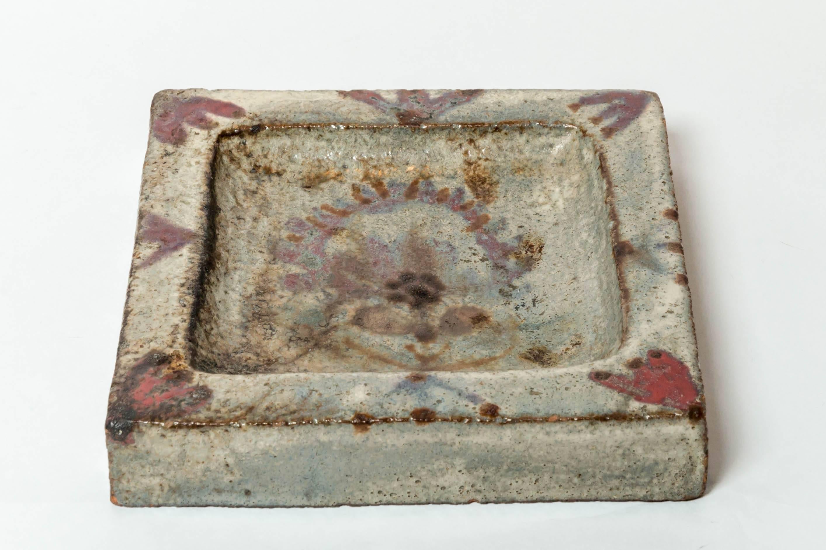 Ceramic tray with hand-painted floral motif by Gustave Reynaud, France, early 20th century.
