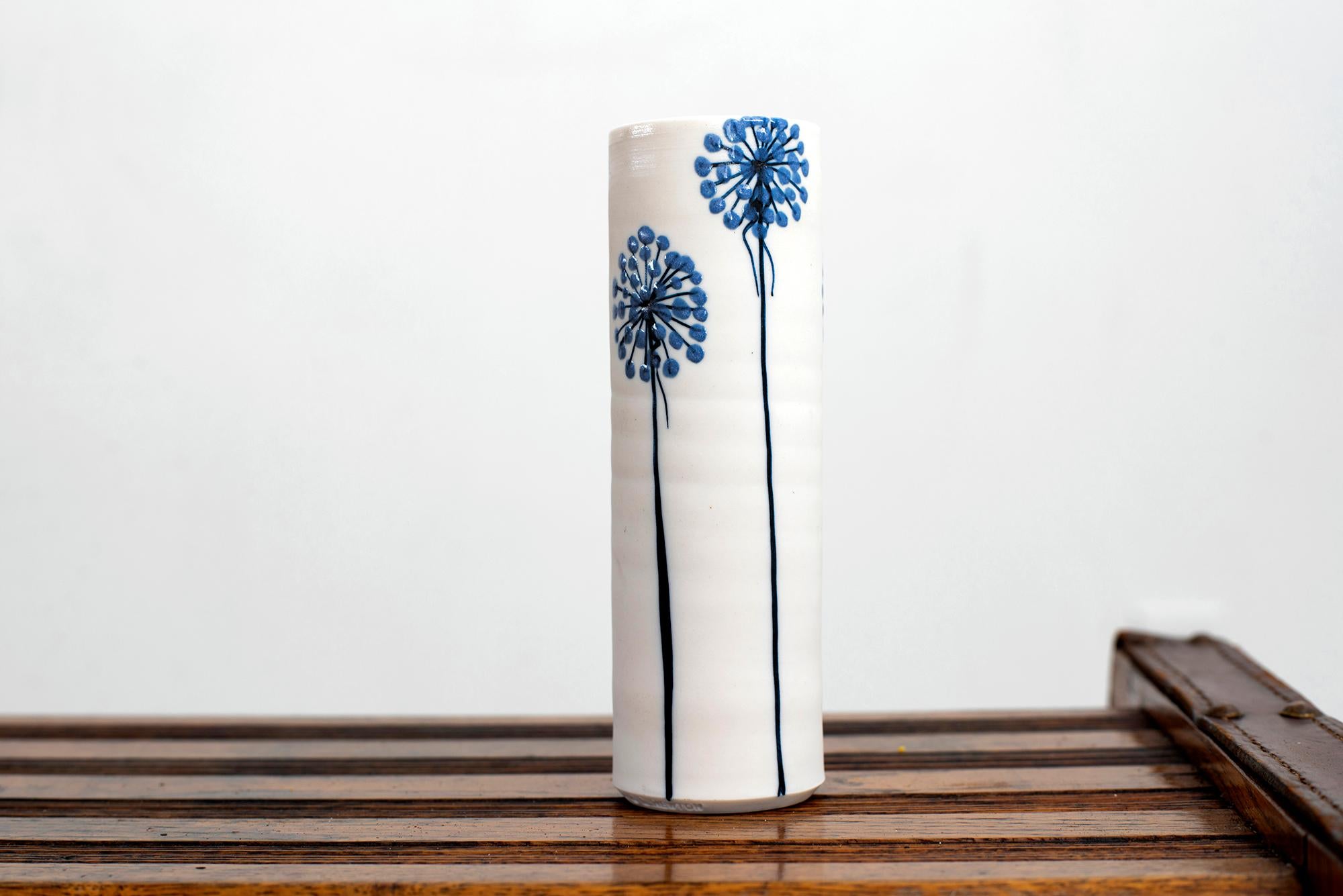 Gorgeous ceramic vase by Alan et Lyn Newton- Cylindrical earthenware ceramic with simple blue flower hand painted.
