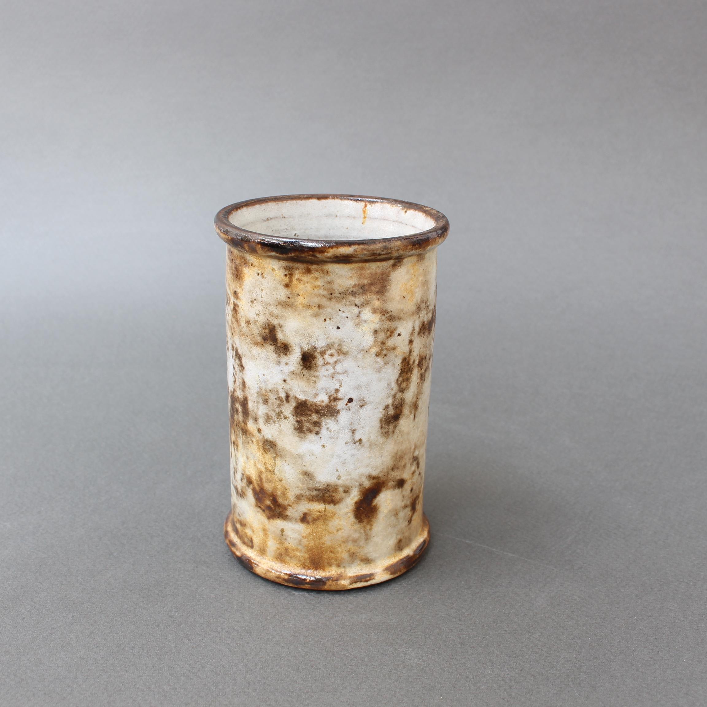 Small ceramic vase by Alexandre Kostanda, (circa 1960s). This ceramic may be diminutive but it is elegant like Kostanda's larger pieces. It presents a misty appearance with earth tones in brown, beige and delicate yellows. It may be displayed on a