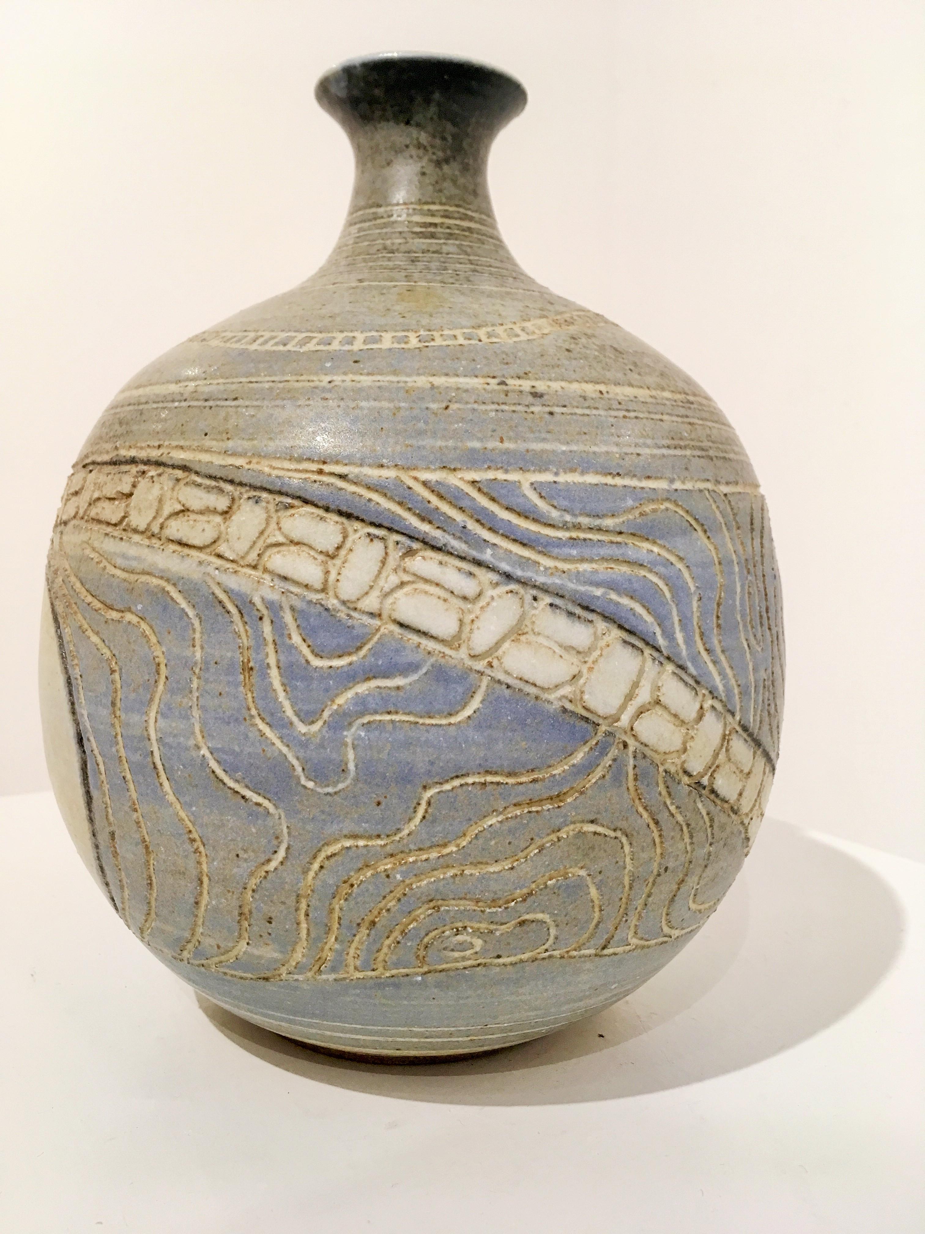 Ceramic vase by San Diego artist Barbara Moorefield. Blue, tan, to light gray in color. Signed (please refer to third image - sixth image shows label used by artist).

The artist described her designs by saying, 