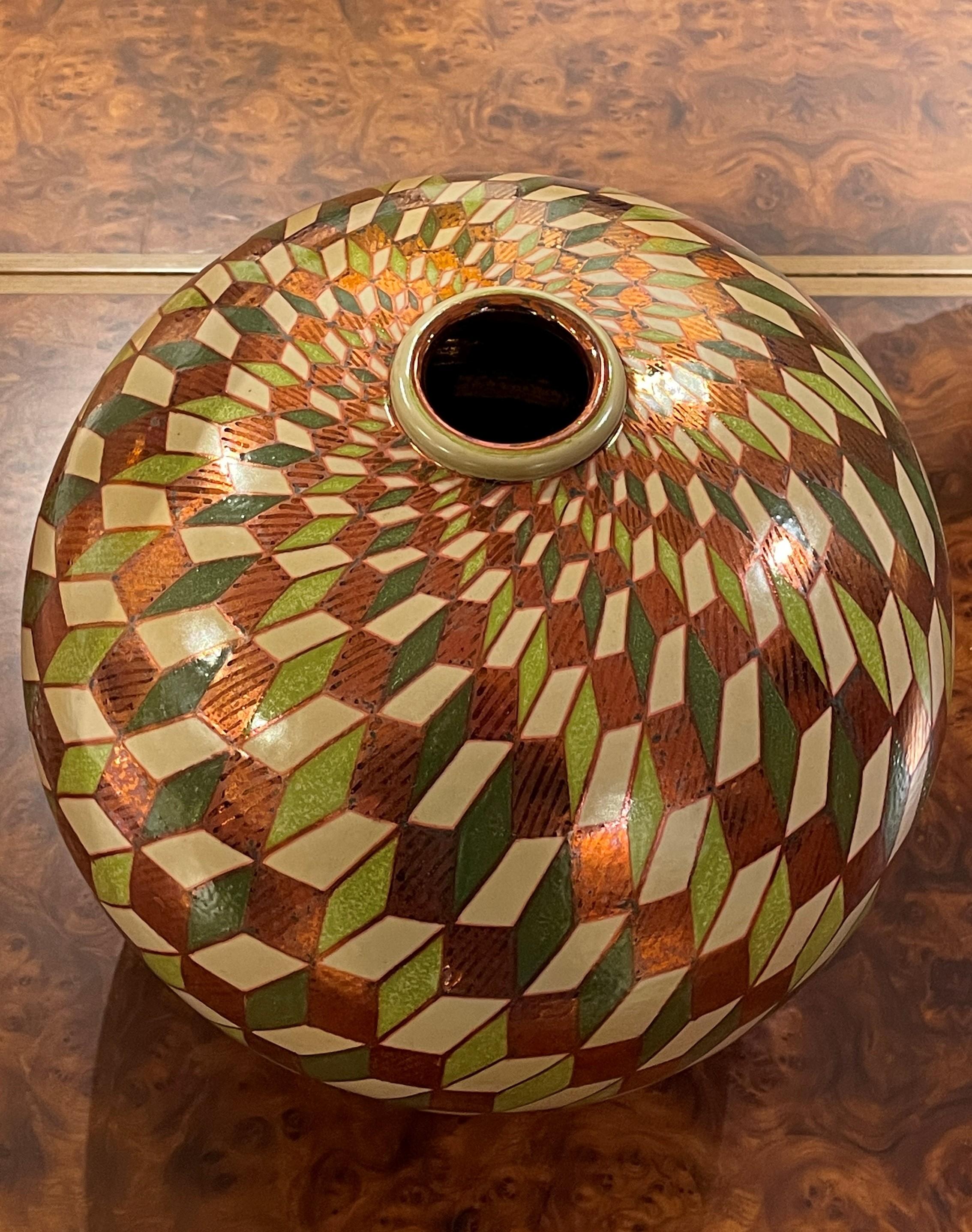 Parallelepipedal moon jar, full-fire reduction faience earthenware, 2017
 35cm diameter, hand-painted unique piece. 

Bottega Vignoli is a brand of artistic ceramics based in Faenza, one of the most representative ceramic production centres in