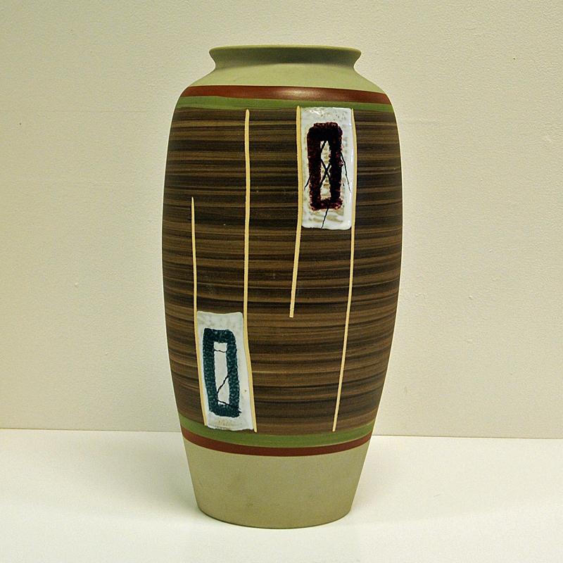 Beautiful and colorful mid-century ceramic vase in creme clay. Polychrome matt glaze. Designed by Eduard Bay in Ransbach-Baumbach, Germany. In good vintage condition. Measures: 40 cmH, 18cmD and 12 cm on top opening. Signed underneath with 281-49