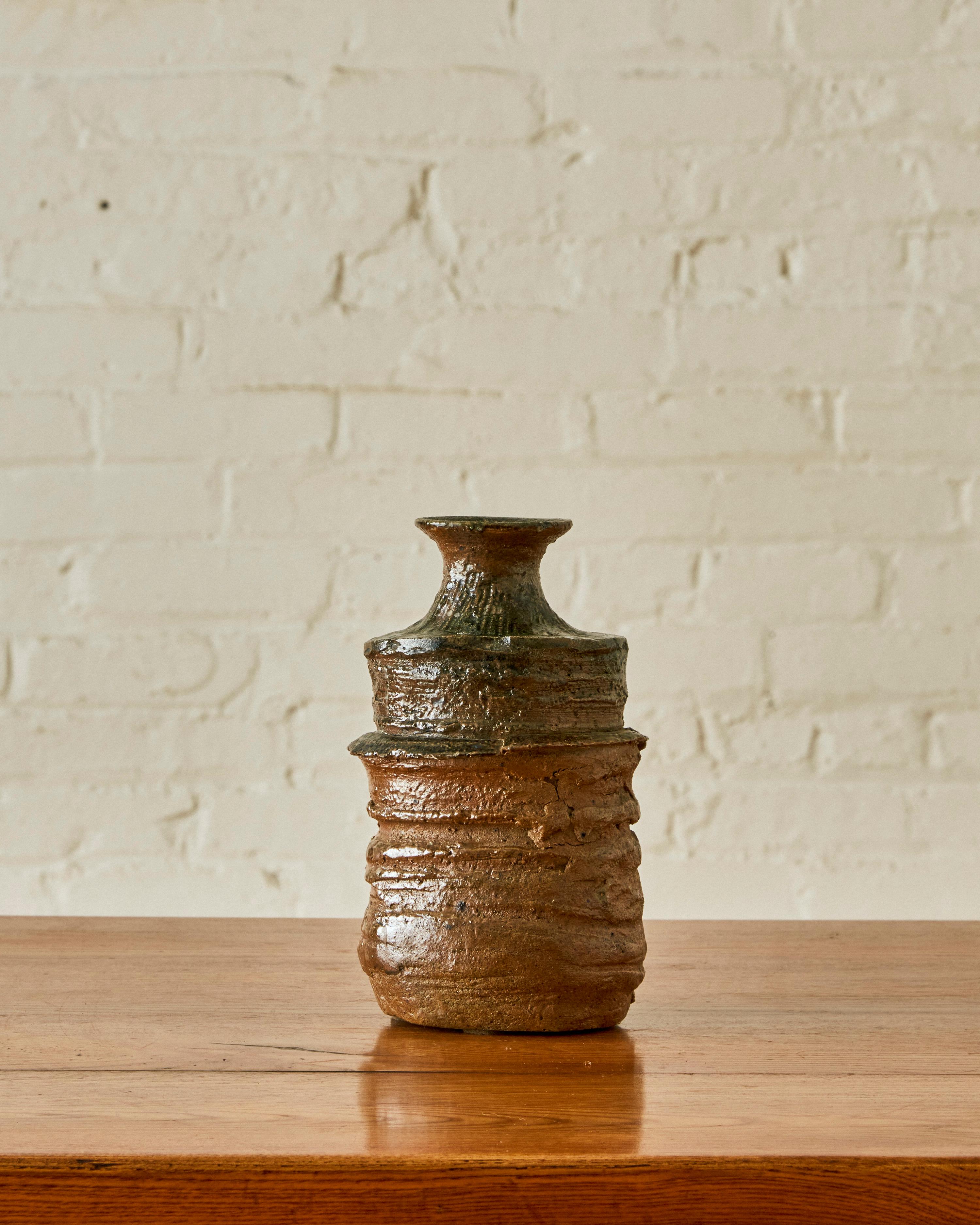 Ceramic Vase by Gerard Brossard with partially glazed, grooved body and flared neck. Signed on the underside.

