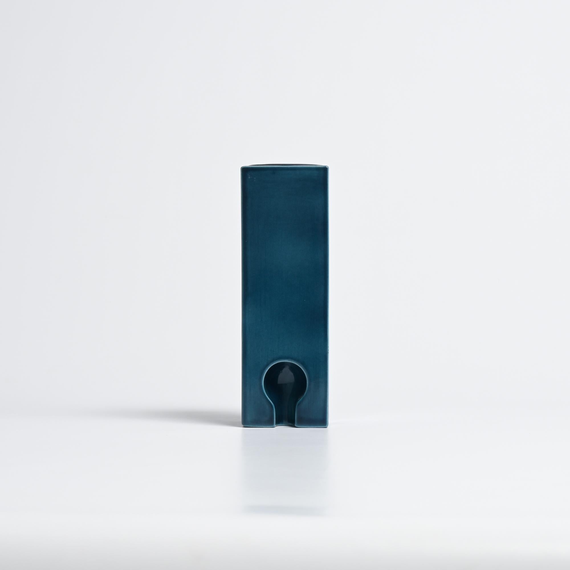 We attribute this vase to Pierre Cardin and date it to the 1970s.

It has a glazed finish and a deep, dark blue-green color.

It is in good condition, showing signs of use and wear consistent with its age.