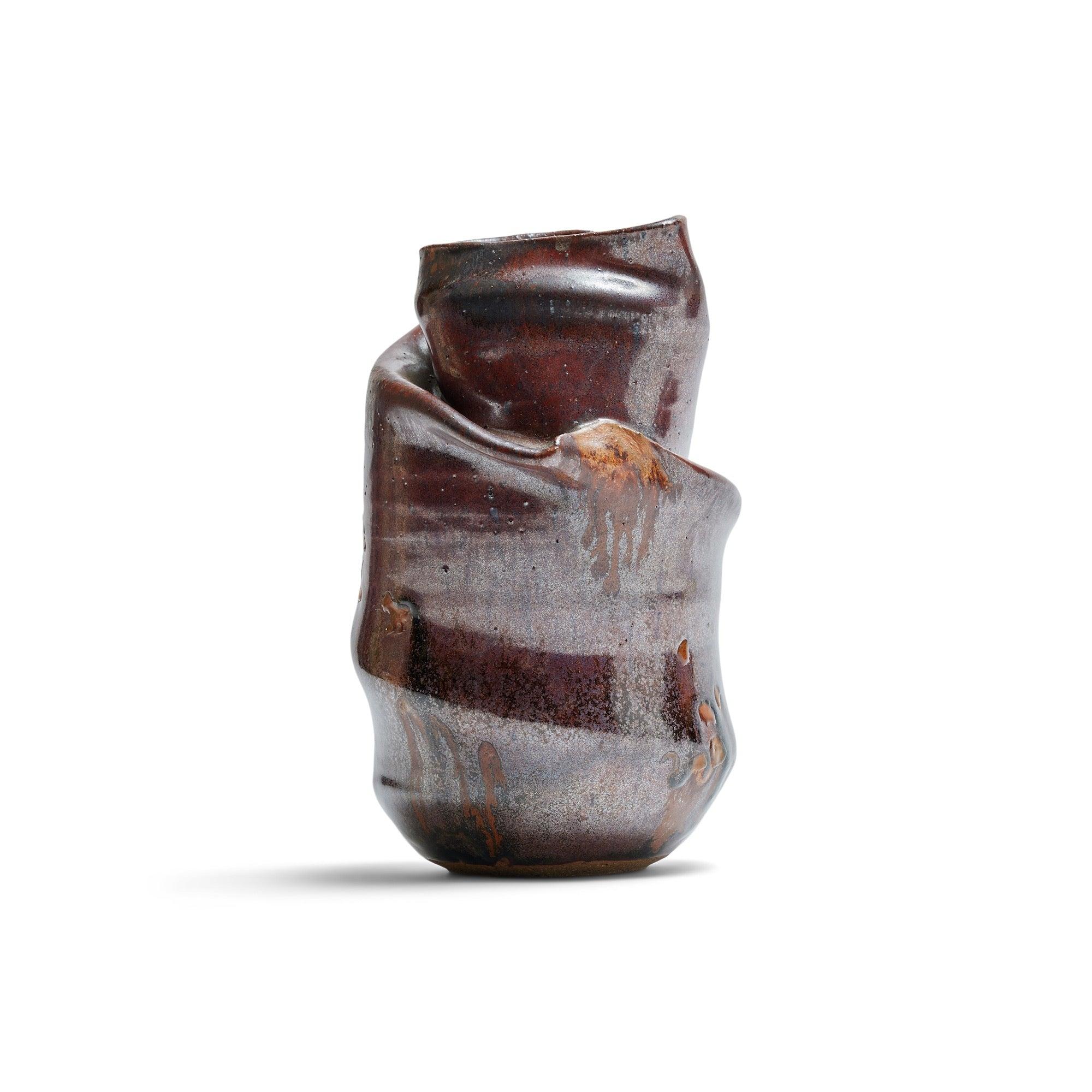A hand-thrown ceramic vase finished in a brown glaze.