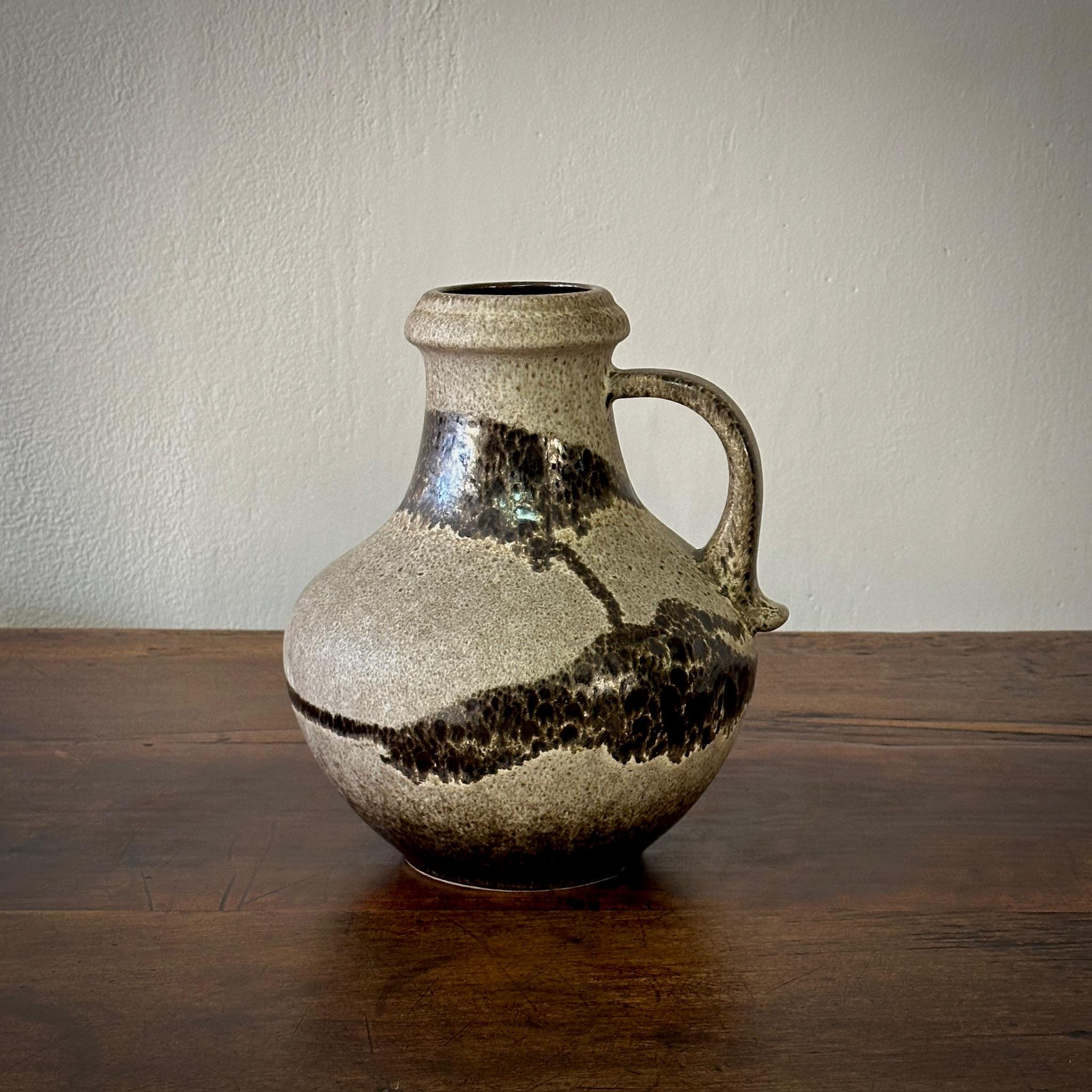 A Belgian glazed ceramic vessel in a pitcher form with deep earth and brown toned glazes. Functional on its own or as a statement displayed in a group with our collection of pottery vessels

Belgium, circa 1970

Dimensions: 9.5W x 8.5D x 11.5H