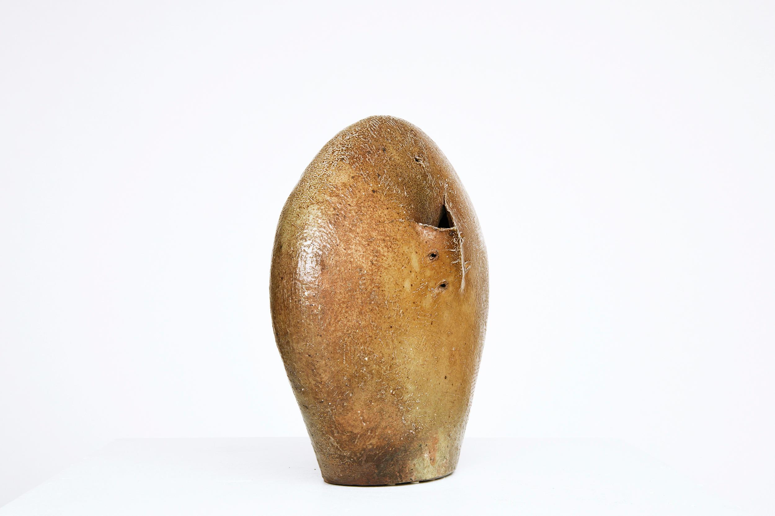 This is glazed ceramic vase by ceramicist Gustave Tiffoche circa 1975. A part of the La Borne ceramic movement, Tiffoche's techinque and glazing represents the pieces made during that time.