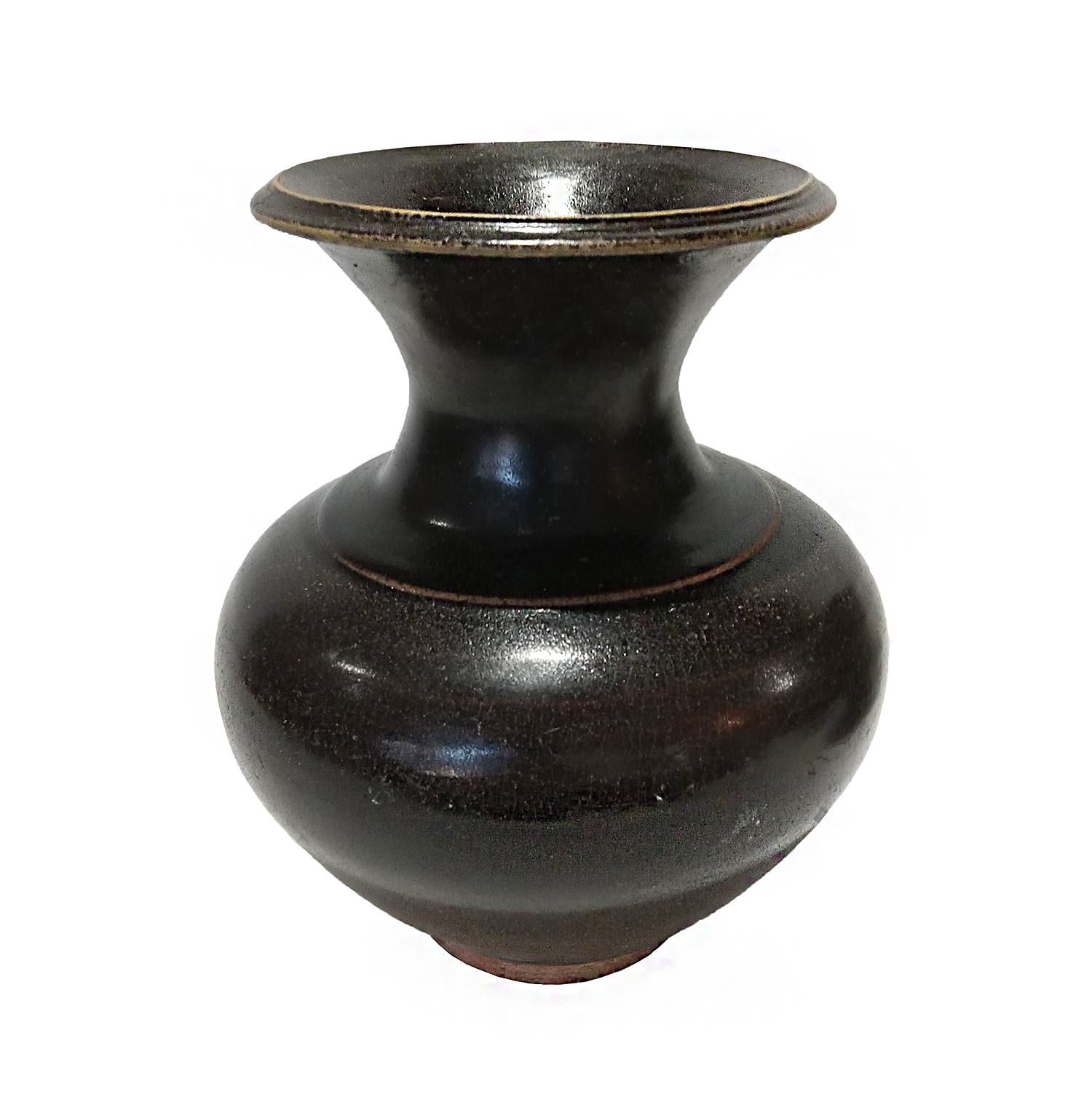 A Thai ceramic vase, glazed in black, early 20th Century. 

Narrow neck with a wide top, curved round body and narrow base. The black / dark brown glaze has a crackled celadon-style finish. 

7 inches in diameter, 8.5 inches high. 