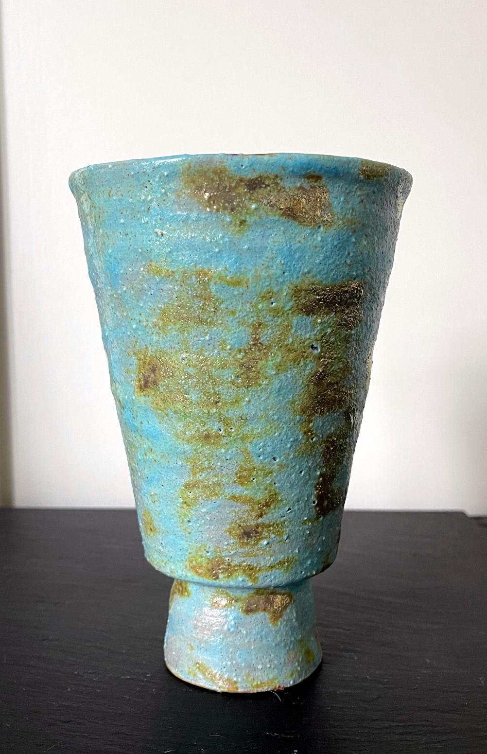 A bespoken ceramic vase by American artist and studio potter Beatrice Wood (1893-1998). The piece, circa 1960-80s, is covered in a beautiful turquoise color volcanic glaze with splashes of metallic gold luster patches. Signed on the bottom 