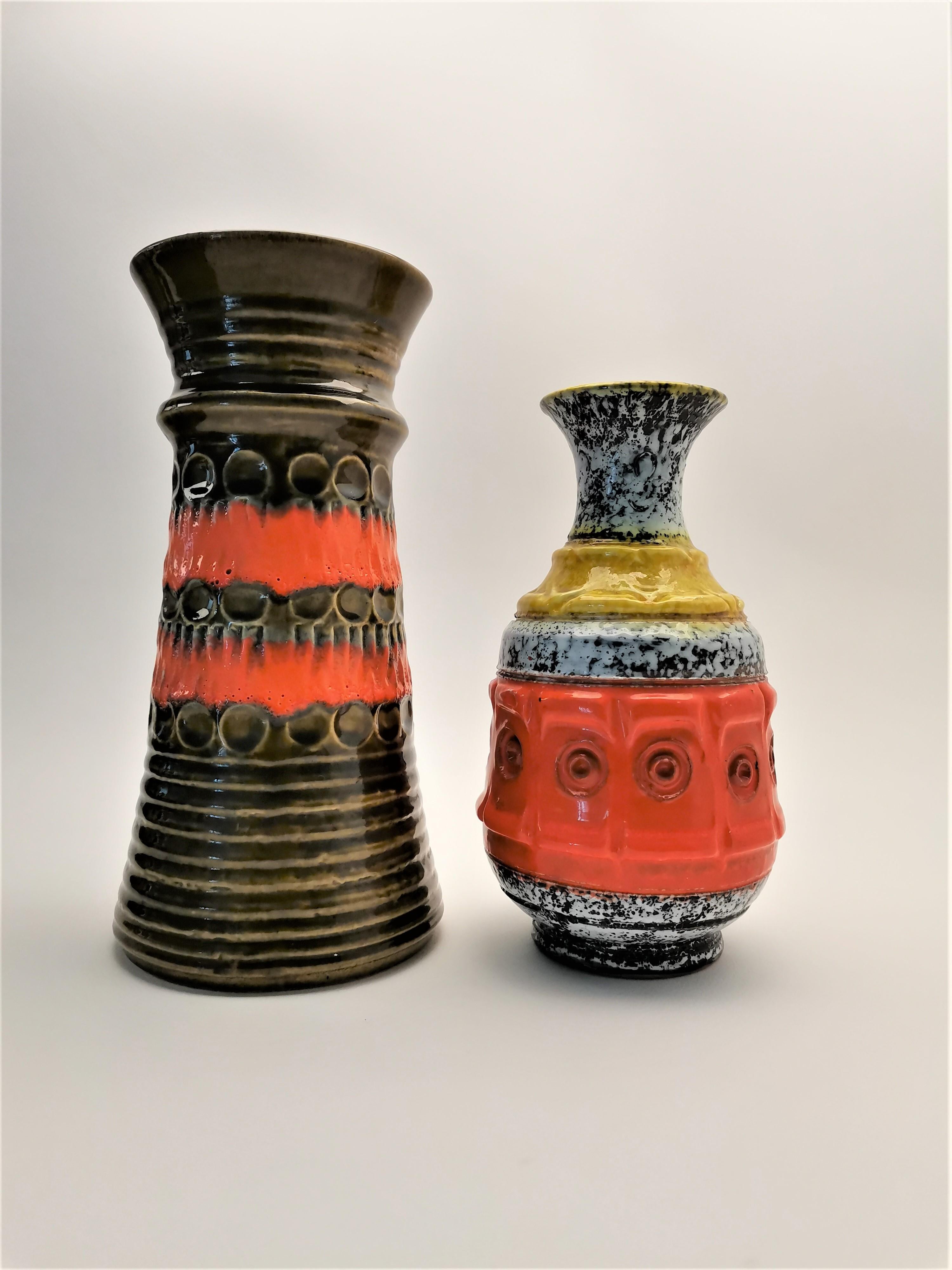 Set of 2 ceramic vases. Made in Germany in 1976. This item is in very good original vintage condition with some signs of use and age. With warm and eclectic esthetics brings to your home some nostalgic memories of the past. 
Period: 1970s
Country of