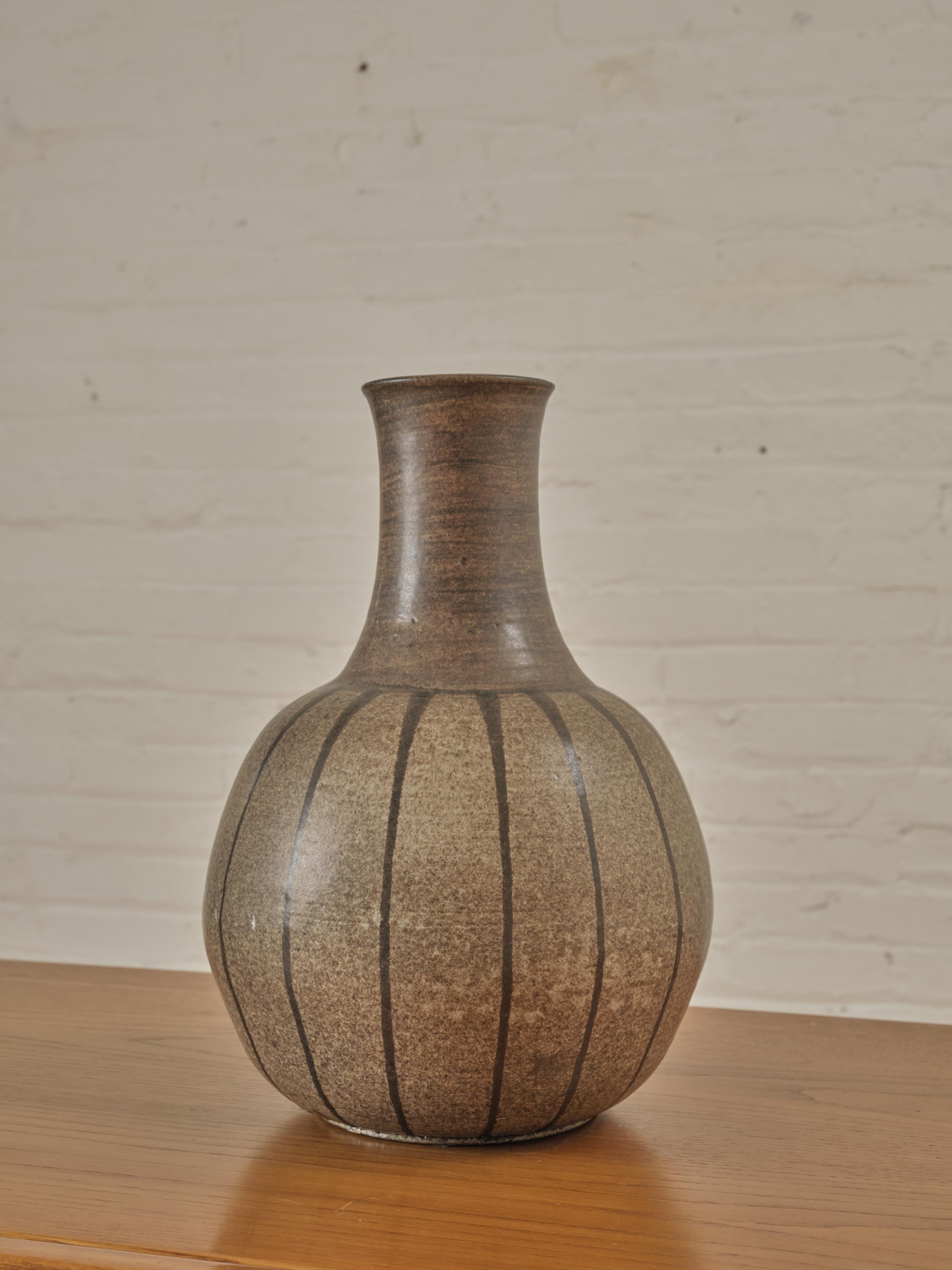Ceramic Vase with by Phyl Lynch with stripe details and variations of brown. Sign engraved on the bottom.


