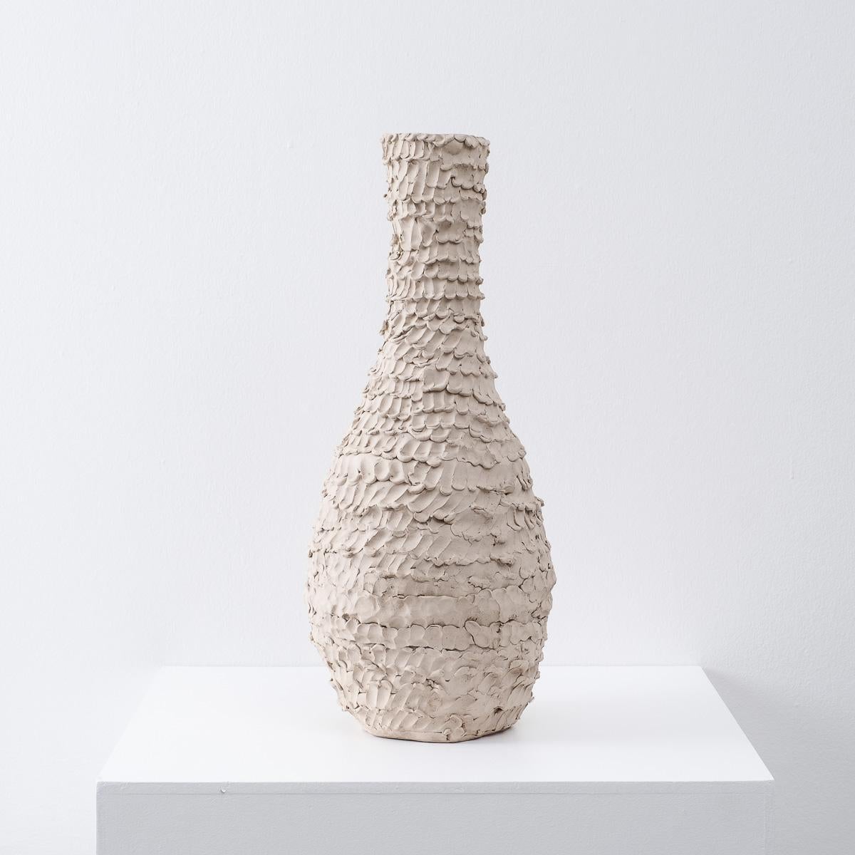 This large ceramic vessel by Hampshire based potter Su Rogers has a really interesting natural texture. The surface marks are made using a simple repetitive finger pressing technique, which give it subtle depth. The silhouette harks back to an