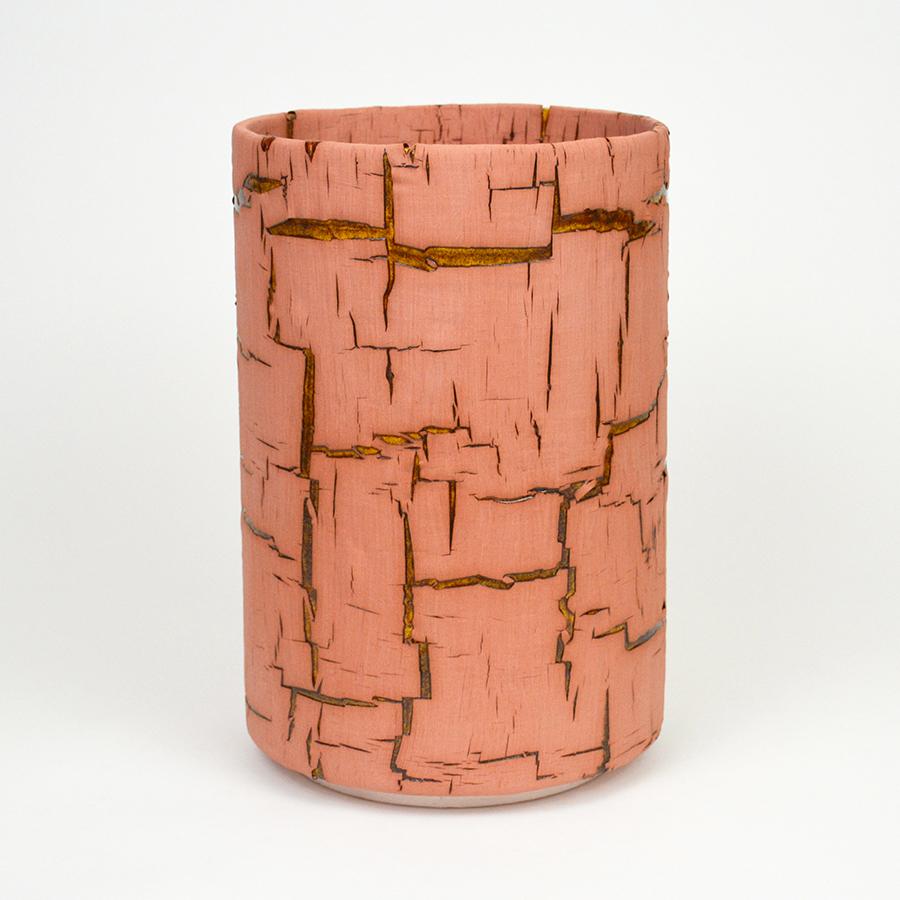 Glazed ceramic cylindrical sculpture by William Edwards
Hand built earthenware decorative vessel, fired multiple times to achieve a textured surface of random abstraction, Pink matte with amber gloss glaze breaking through.

William received his BFA