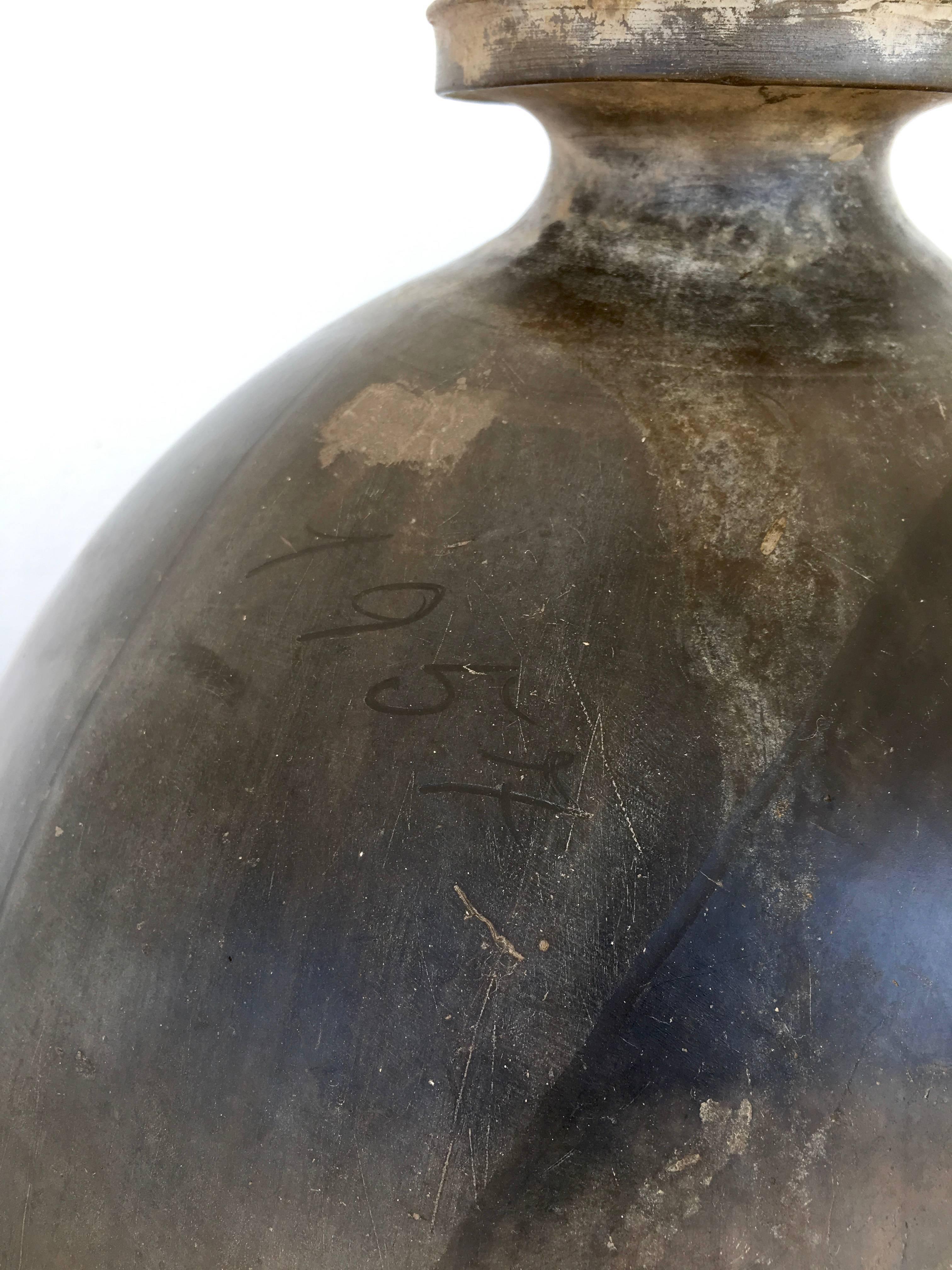 Ceramic black clay pot from San Bartolo Coyotepec, Oaxaca dated 1957. Jugs such as these are extremely rare and date between the 1940s and late 1960s. Dated pieces are even difficult to find. The date and artist's name 