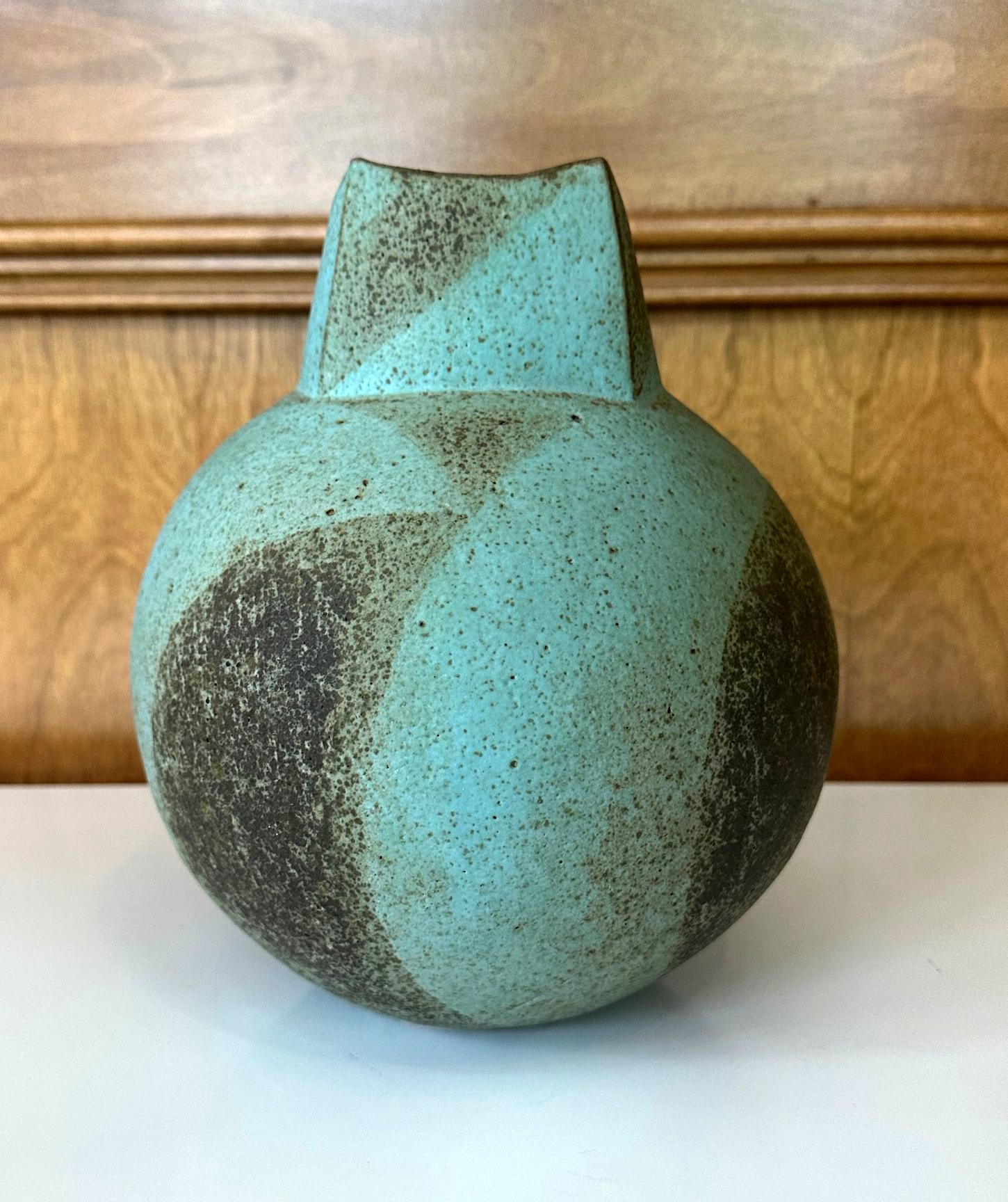 A stoneware vessel with a distinct form and glaze by British studio potter John Ward (1938-2023) circa 1990s. This specific form in the artist's repertoire may be known as a 