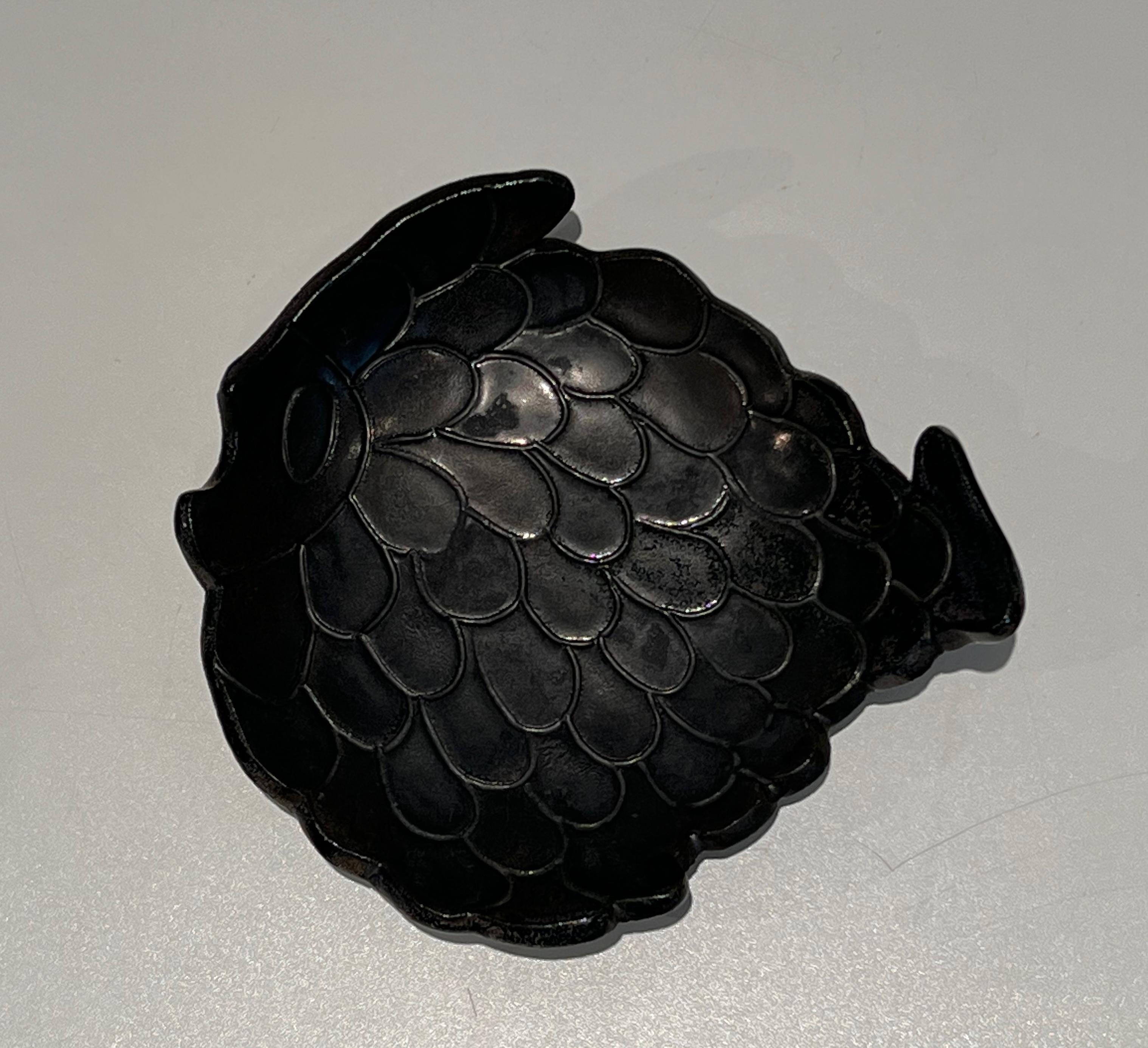 Ce vide-Poche représentant un poisson est en céramique noire. Il s'agit d'un ouvrage français. Circa 1970