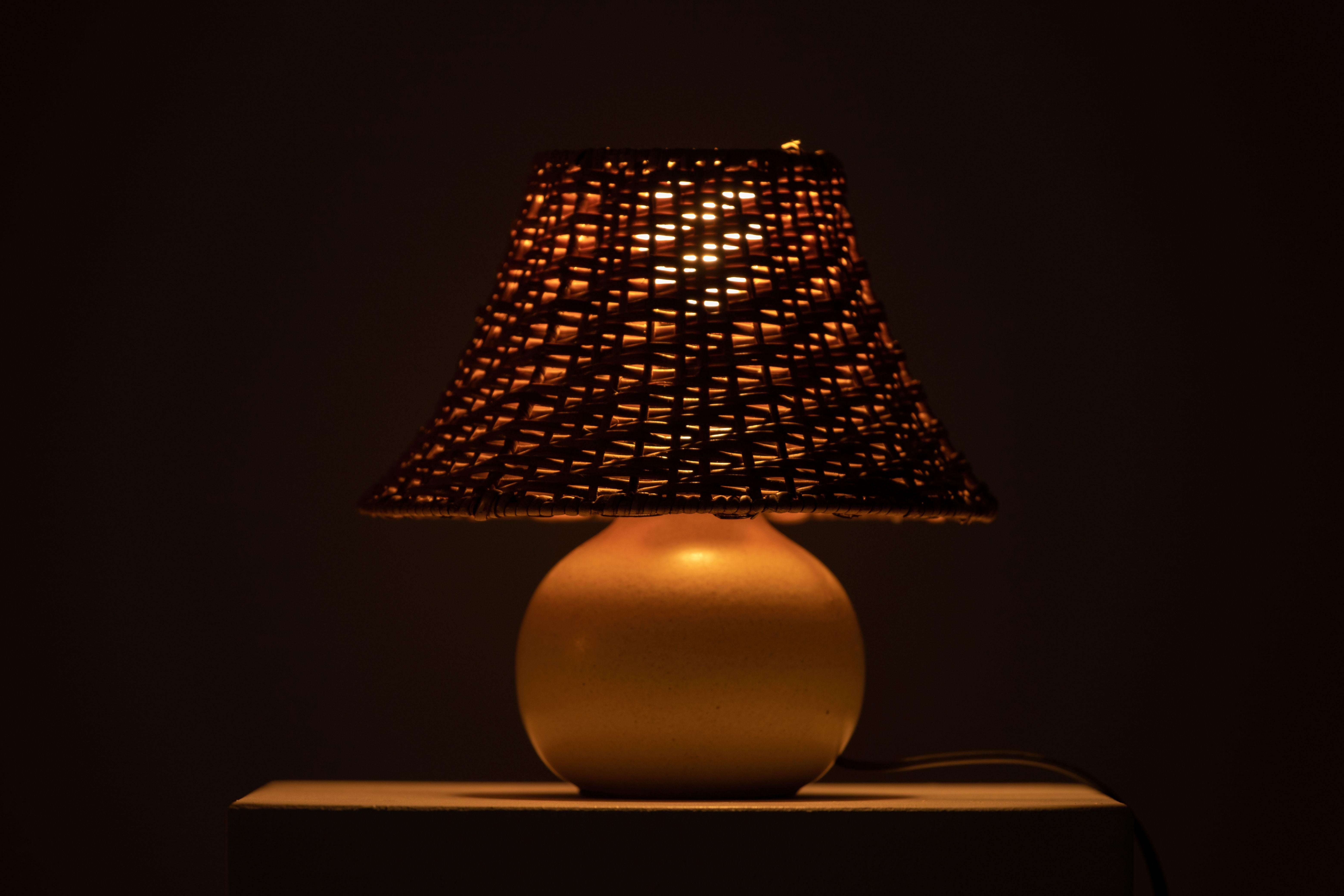 Introducing a charming mid-century ceramic table lamp from France, crafted in the 1960s. This elegant lamp features a beautiful ceramic base and is accompanied by a stylish rattan lampshade.

Preserving its original charm, this lamp is in