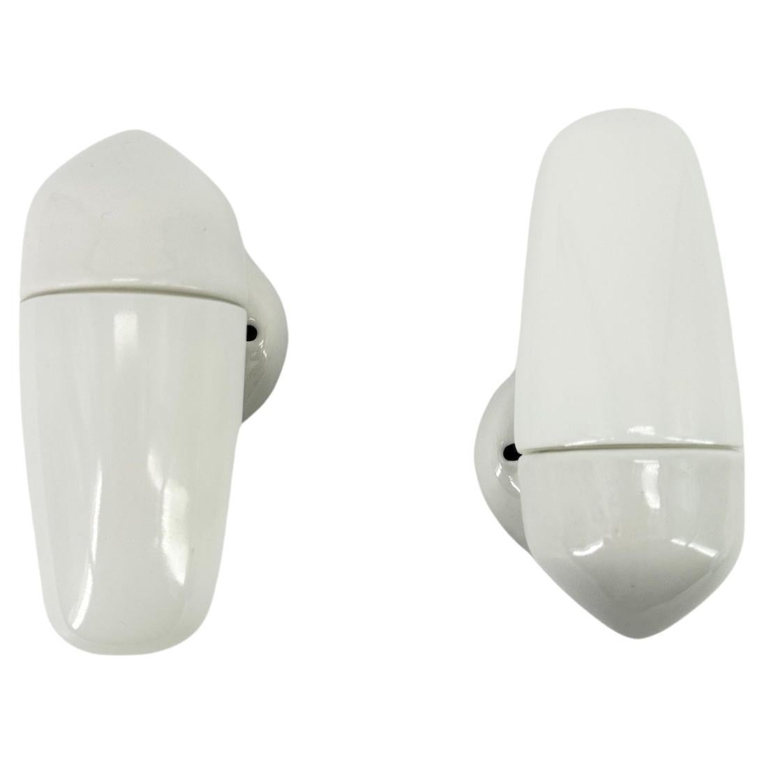 Wall light in white porcelain and opaline glass shades were designed by the German designer Wilhelm Wagenfeld, who studied at the Bauhaus school. 

This model dates from 1958 with sleek, round and elegant lines, a timeless design that will look