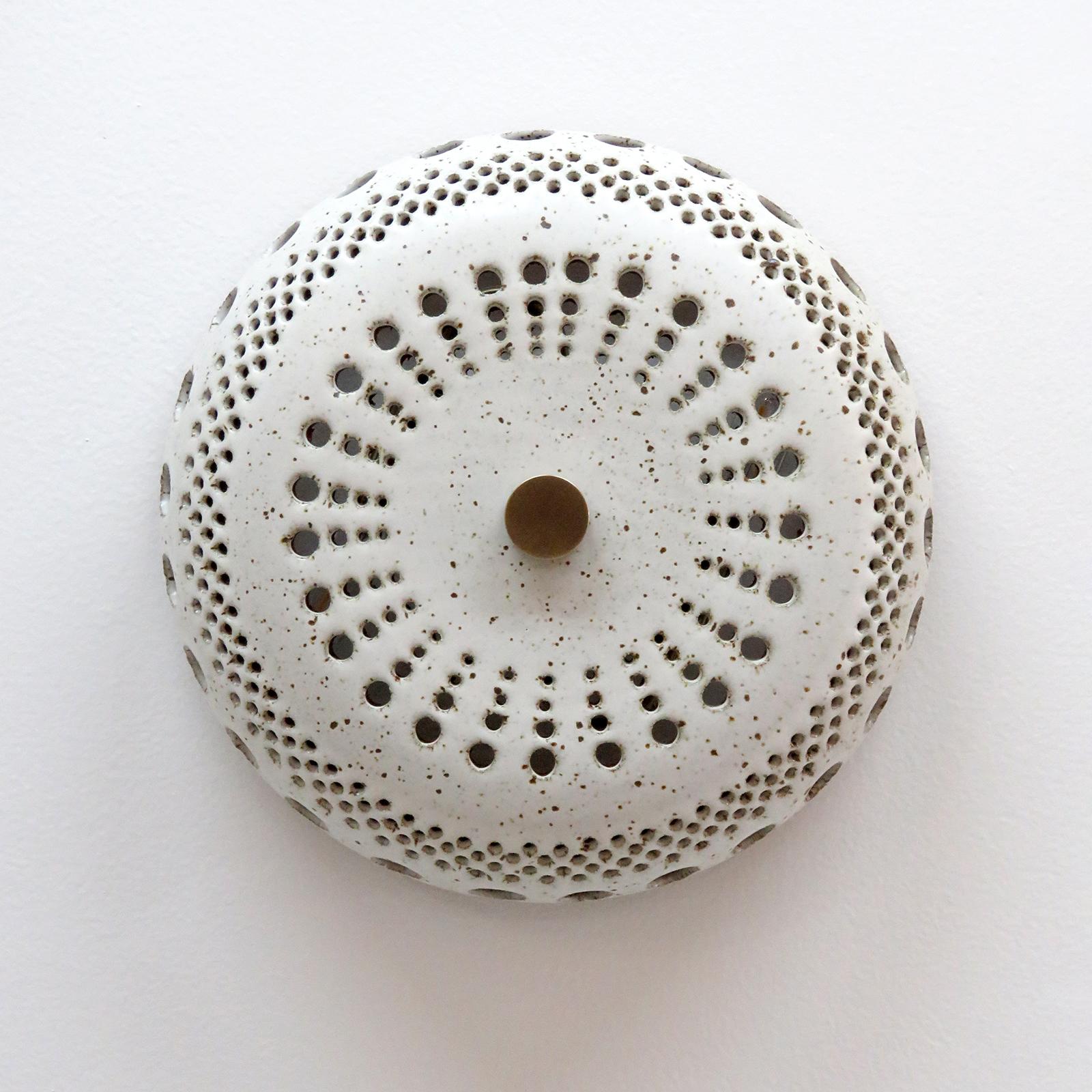 Stunning ceramic light No.12, designed and handcrafted by Los Angeles based ceramicist Heather Levine. High fired stoneware with matte white glaze on a cork colored clay body with decorative perforations to expose light in patterns on nearby