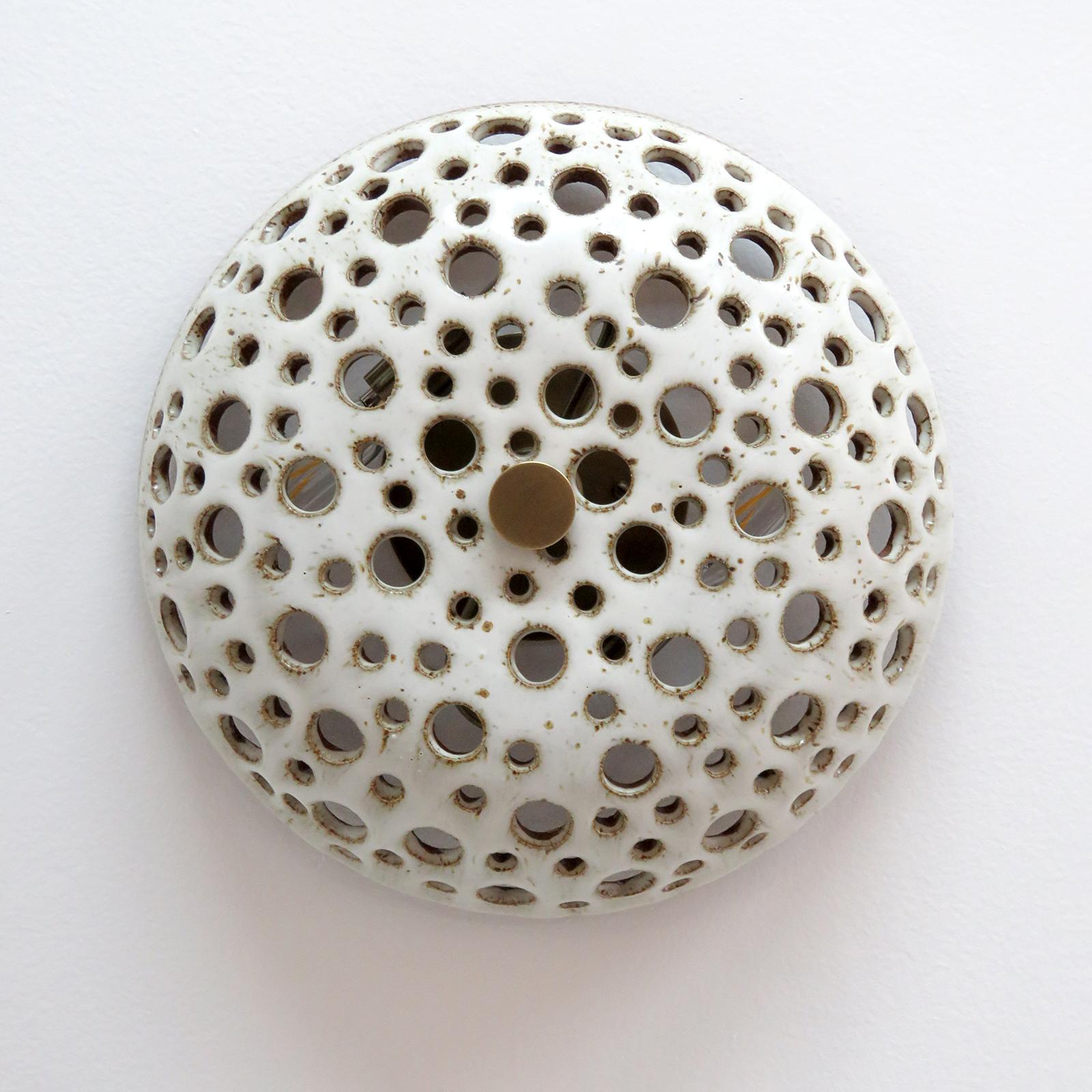 Stunning ceramic light No.9, designed and handcrafted by Los Angeles based ceramicist Heather Levine. High fired stoneware with matte white glaze on a cork colored clay body with decorative perforations to expose light in patterns on nearby