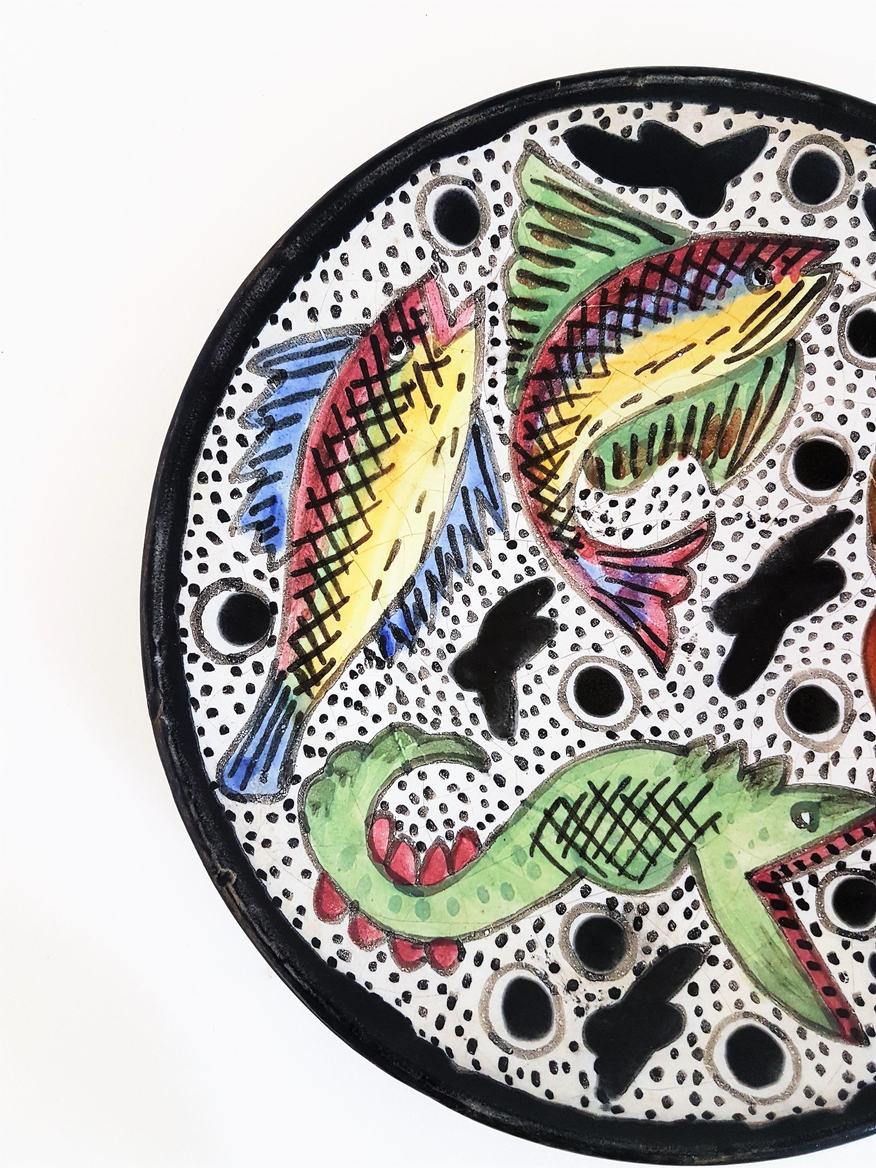Hand painted Naif fish design terracotta wall plate
Beautiful mid-20th century terracotta plate with hand painted naif fish decoration. 
Signed Solé. 
Catalan school, Spain 1950s.
A lovely plate to use as wall decoration or centerpiece.