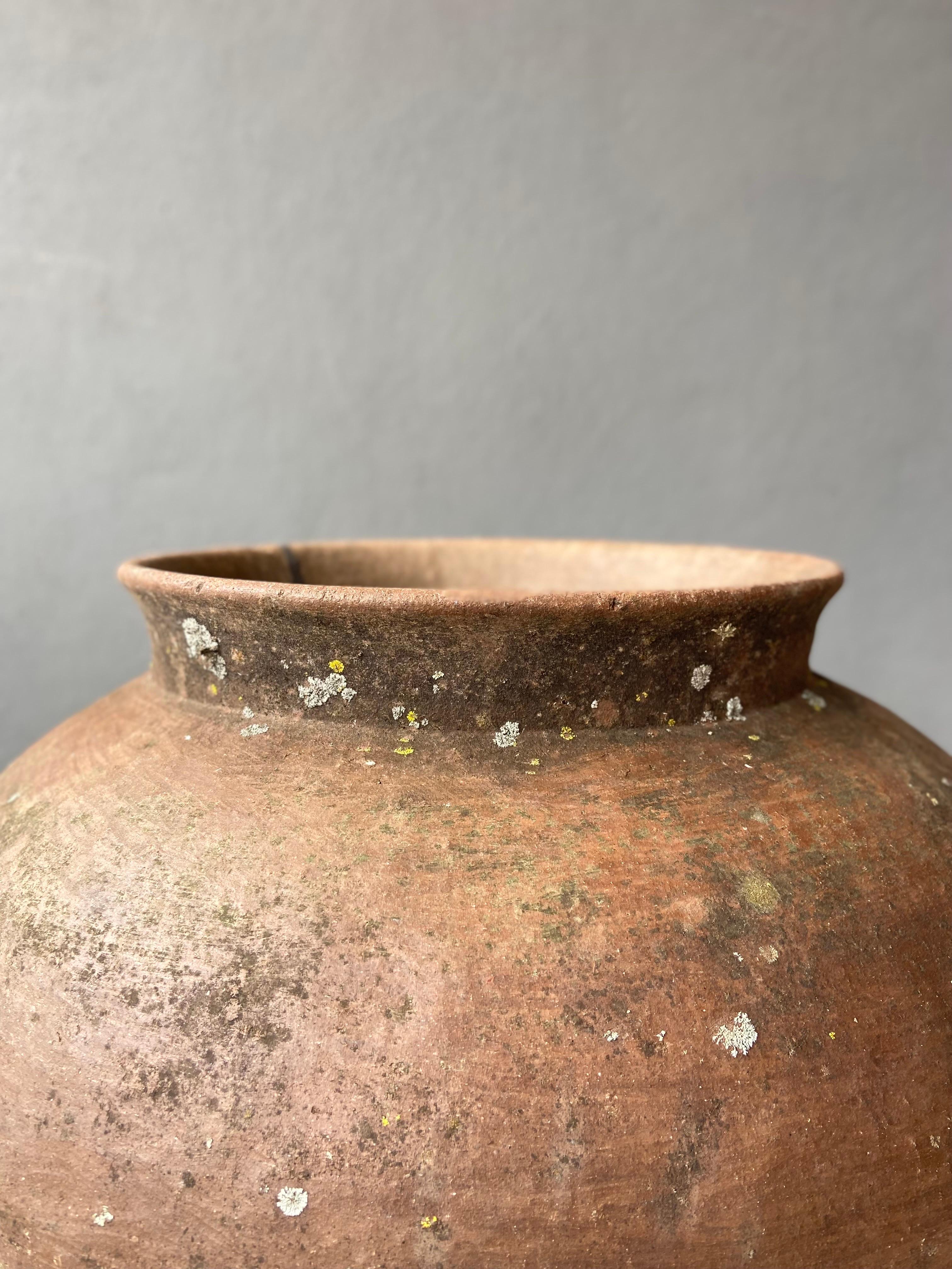 Ceramic wide mouth water pot from the Mixteca region of Oaxaca, circa mid 20th century. Two discerning elements about Mixteca pottery are the form and the color of the clay once fired. We approximate this vessel to be from the 1940s or 1950s.