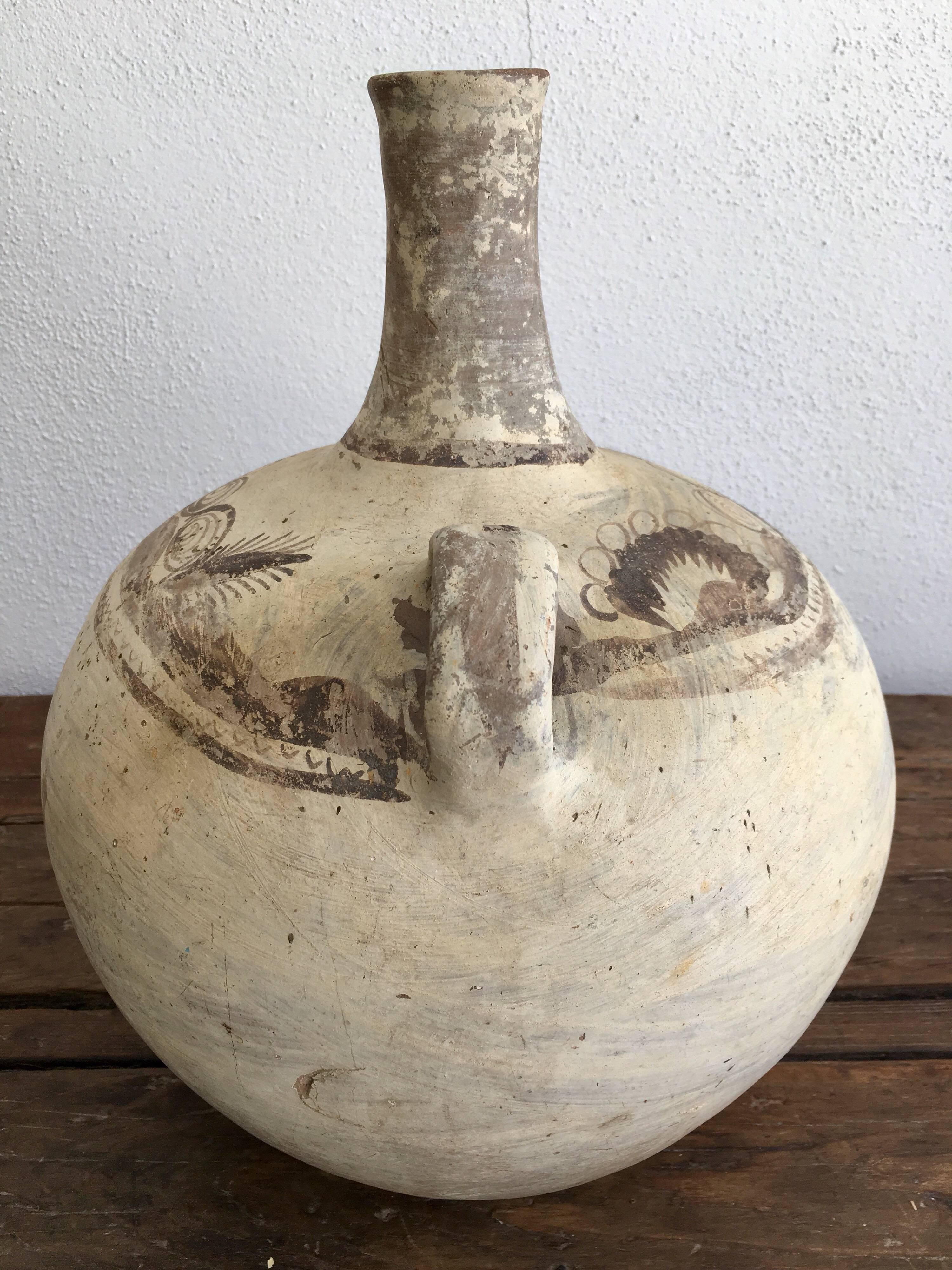 Long-neck water pot from the Hidalgo region of Mexico. Used for water or pulque. Drawing motif is still visible.