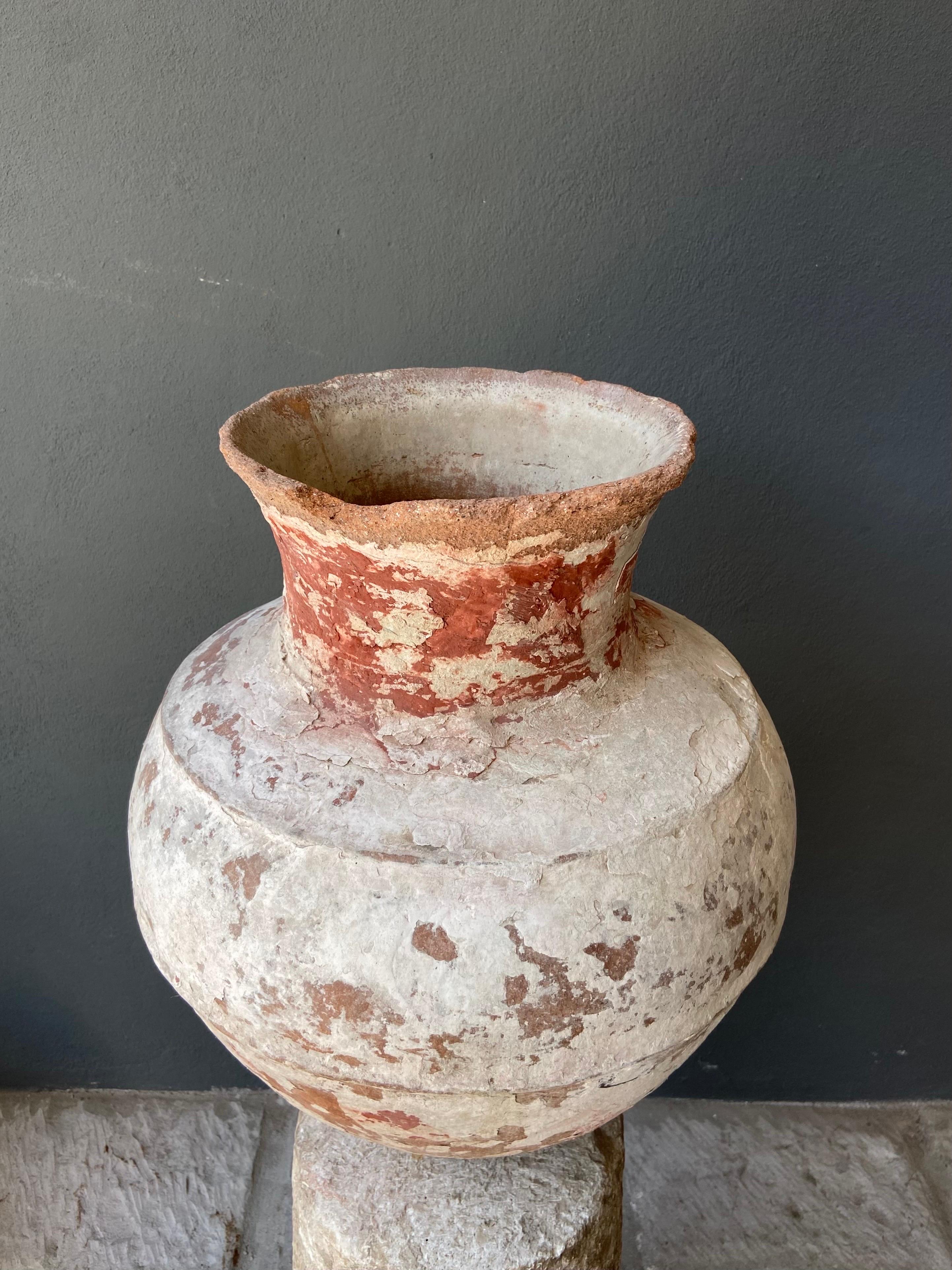 Ceramic water vessel from Central Yucatan, Mexico, circa early 1900s. The original color of the clay is an orange/red, however the piece was repeatedly covered with a lime wash plaster to keep the water cool. Through time and repeated application of