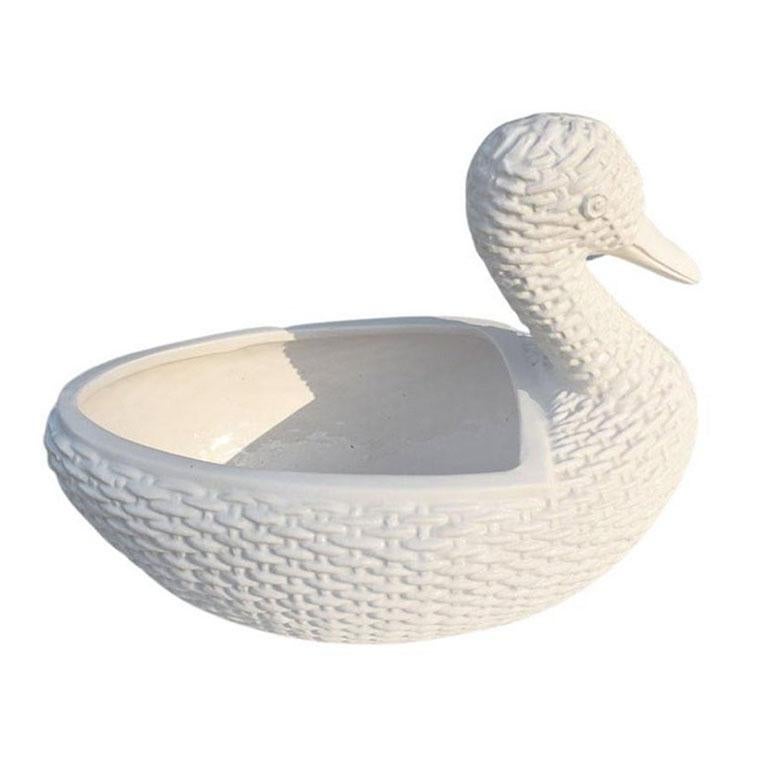 A ceramic creamy white faux wicker duck planter. This piece would be fabulous on a patio planted with your favorite plant. 

Dimensions:
12