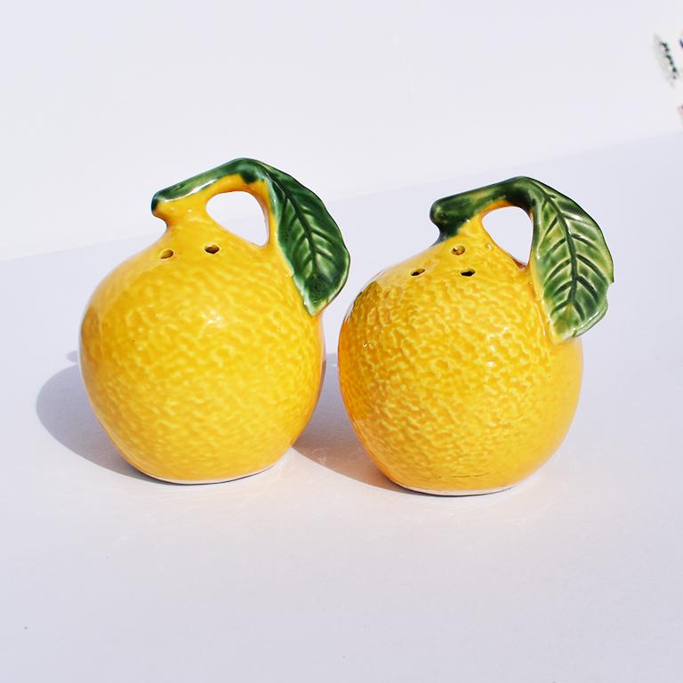Pair of yellow lemon salt and pepper shakers. Lovely round fruit shakers in ceramic. Bottom signed 