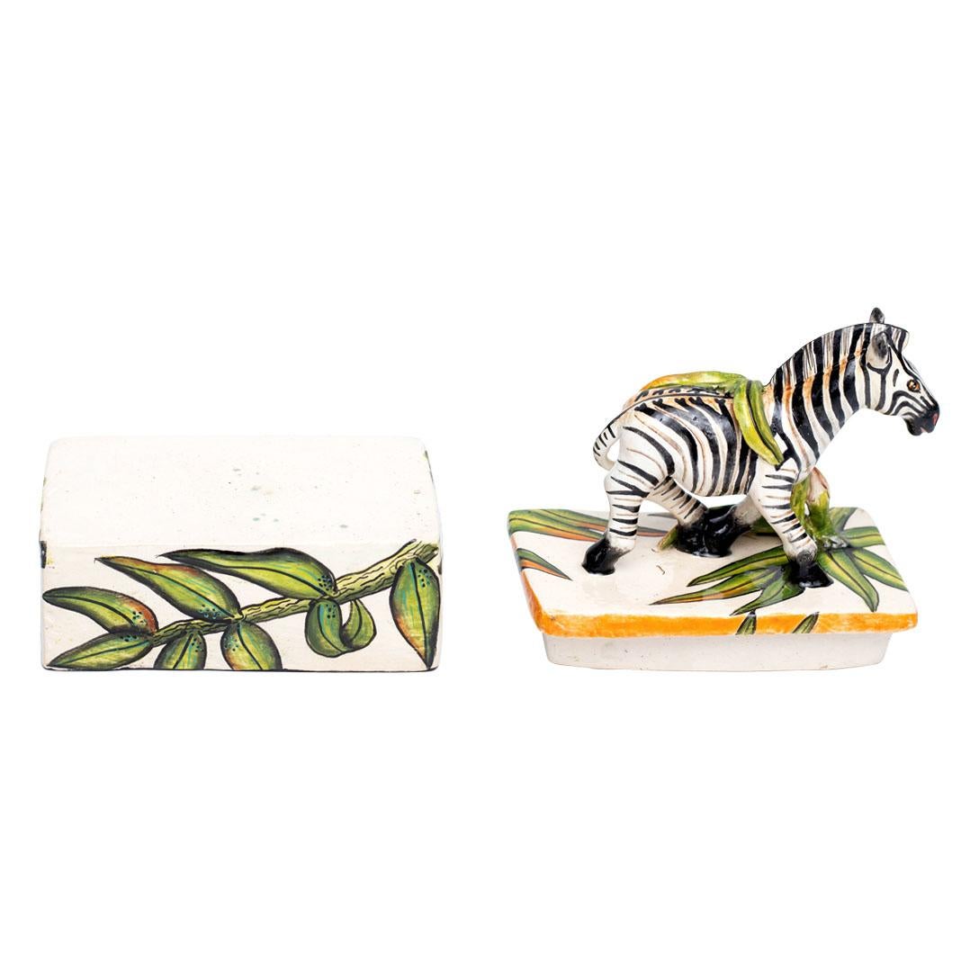 Introducing the Ceramic Zebra Jewelry Box from Imvelo Natural Art, South Africa. Hand-sculpted by Bennet Zondo and hand-painted by Samukelo Gumede, with design contributions from Senzo Duma, this exquisite box measures 5 inches in height, 5 inches