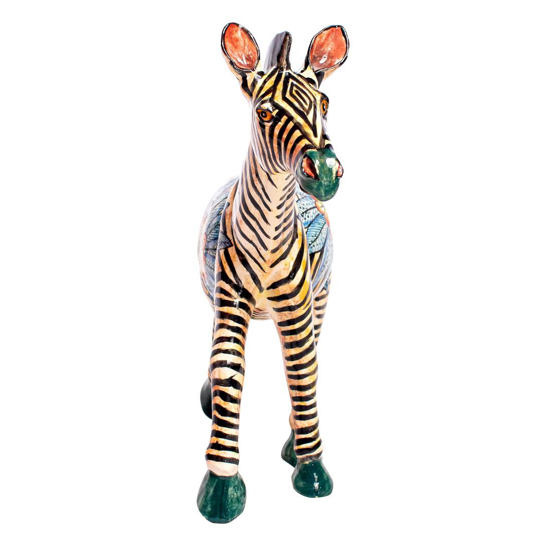 Wiseman Ceramics' hand-sculpted and hand-painted ceramic Zebra sculpture, designed by Riya and crafted by Thabo, lovely piece one of the kind very nice colors with a flower design in its side perfect for your home or office,stands 10 inches high,