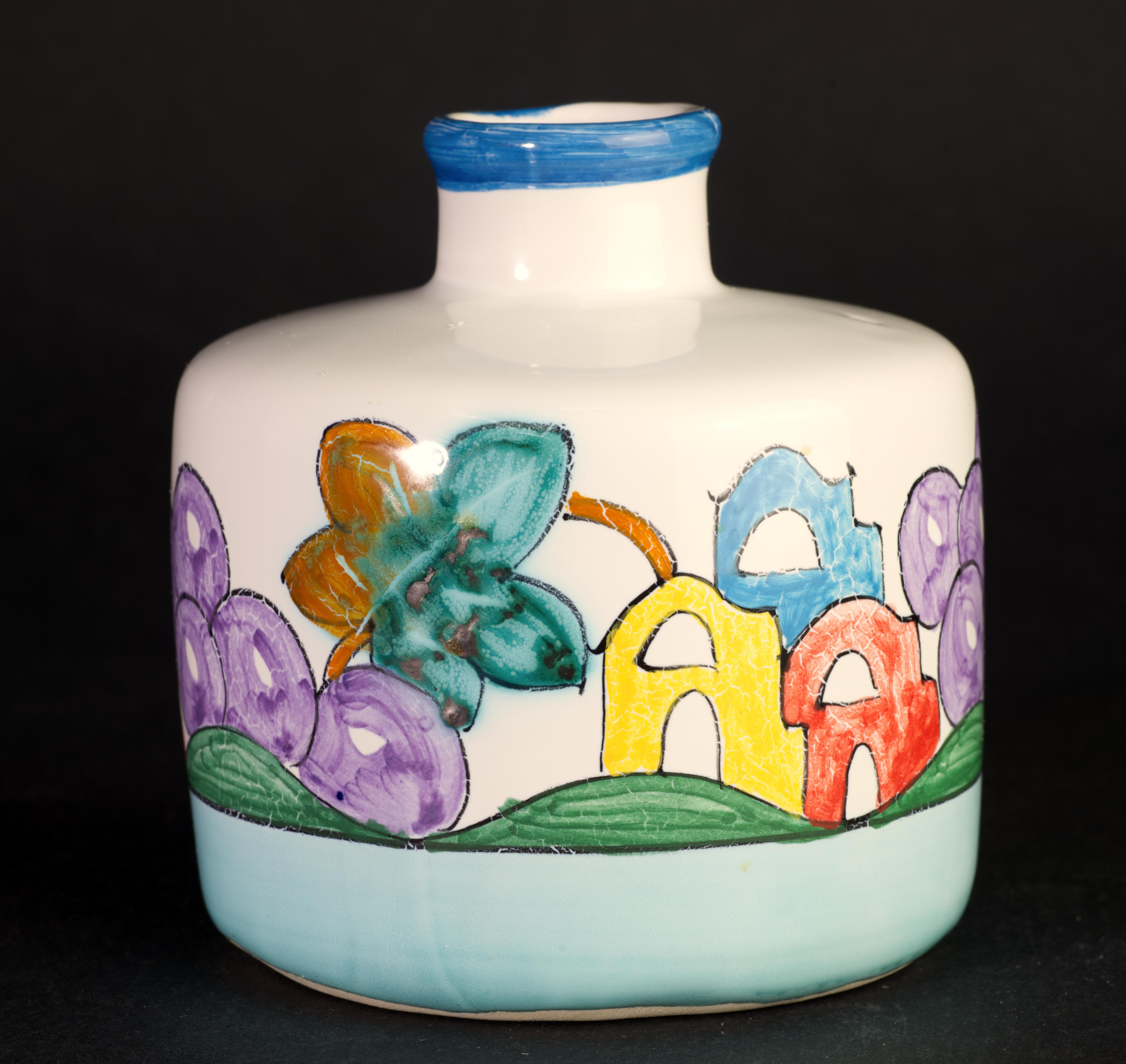  Playful bud vase is hand painted with bright and cheerful decor of houses, fruits, and flowers that wraps around the vase and creates a surrealistic landscape. The rim is defined with a blue band.

Ceramiche Daedalus Vietri is an art pottery studio